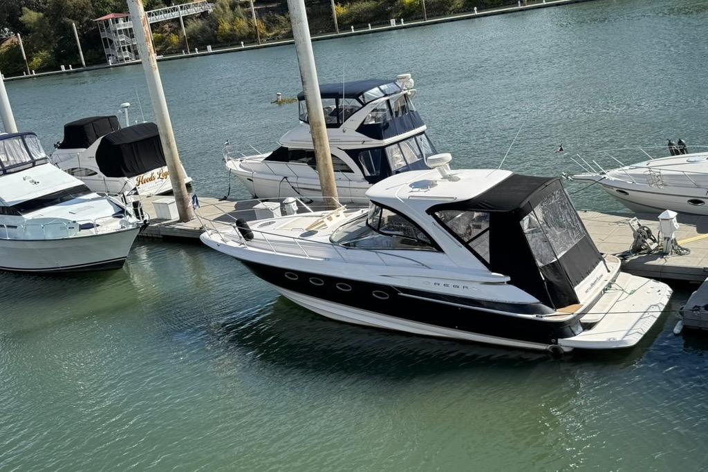 2006 Regal Commodore 4460 yacht docked at marina, surrounded by other boats.