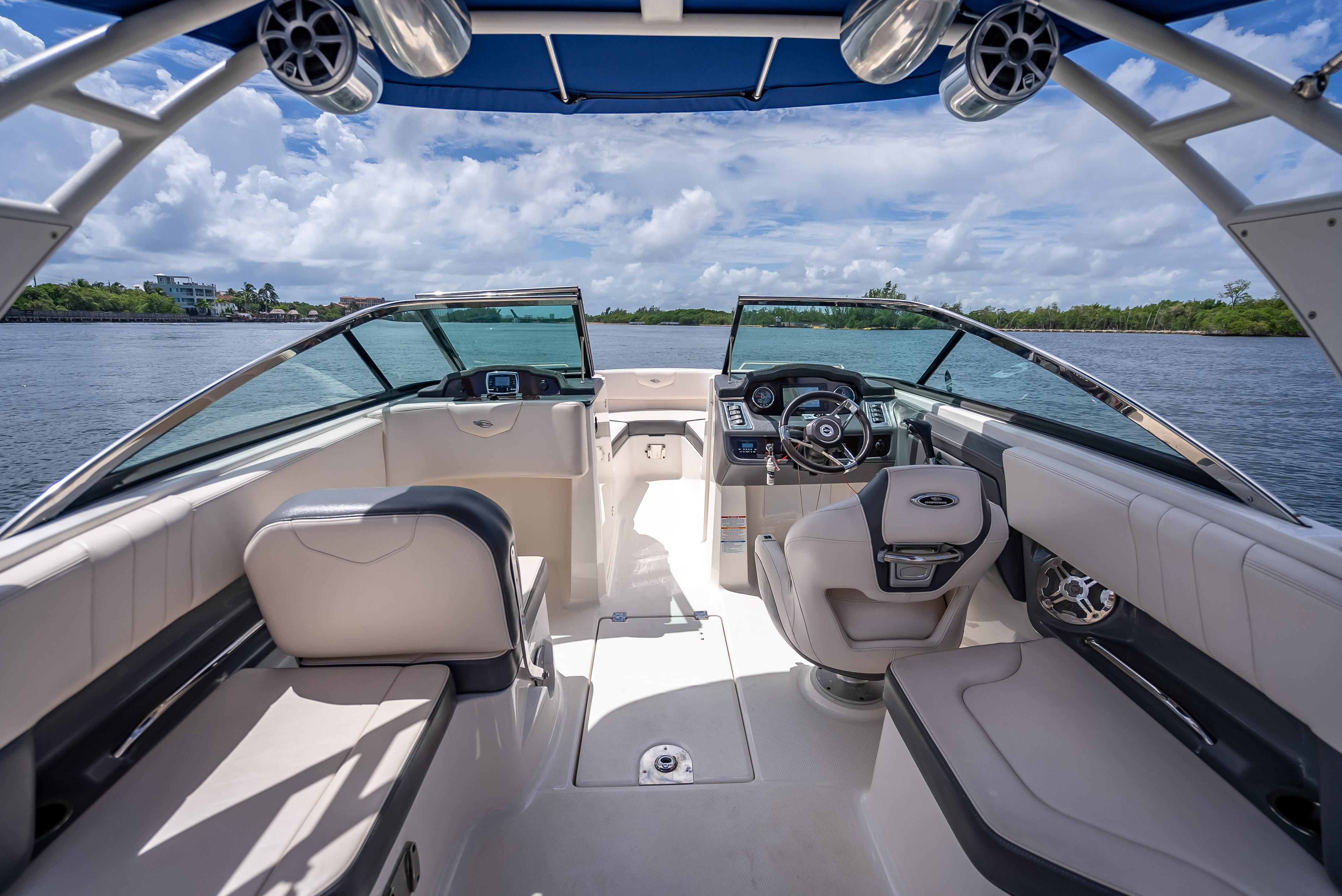 2017 Chaparral 227 SSX boat interior with luxurious seating and modern dashboard on a sunny day.