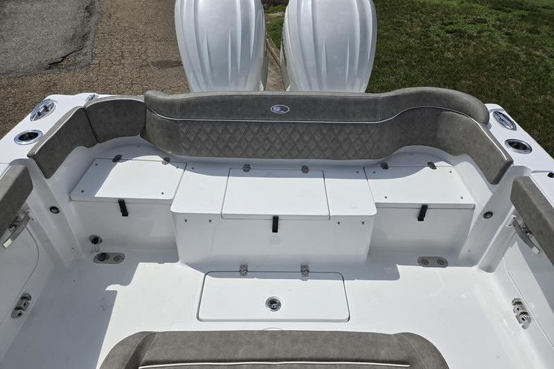 2027 Sea Hunt Ultra 275 SE boat interior with cushioned seating and storage compartments.