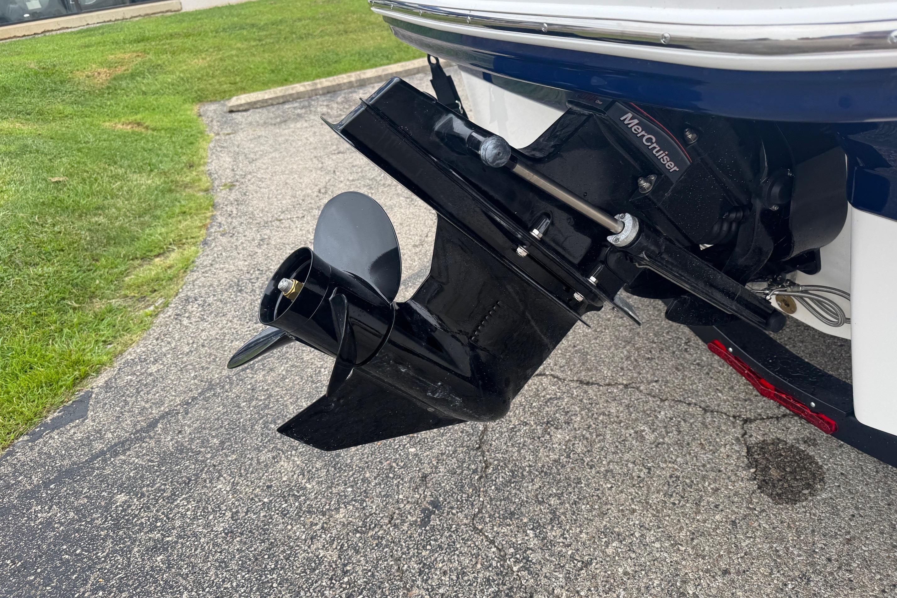 2026 Chaparral 21 SSi boat with MerCruiser outdrive on pavement.