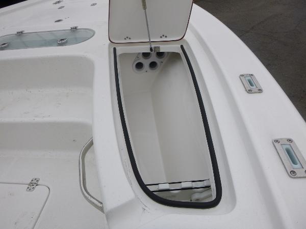 2025 Sea Pro 250 Bay boat storage compartment with open lid.