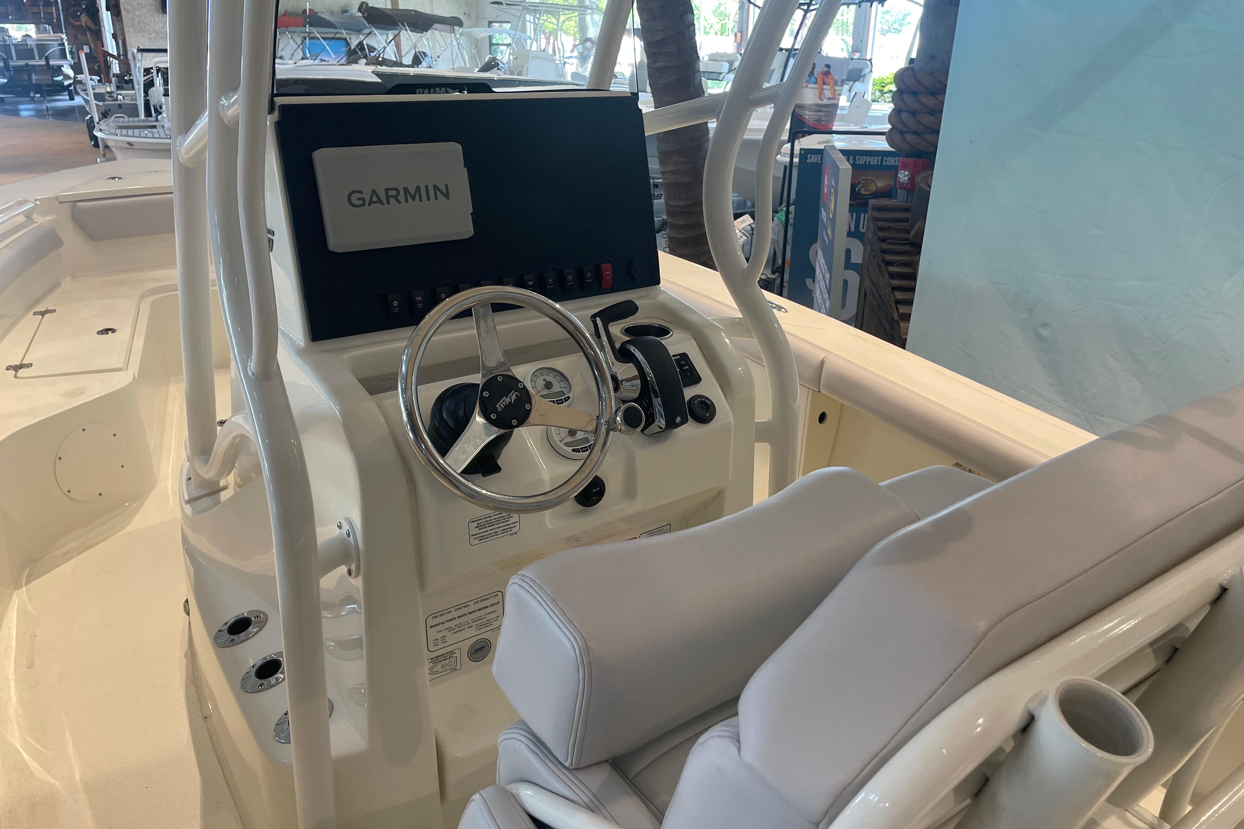 2026 Mako 226 Center Console boat interior with Garmin navigation system and steering wheel.