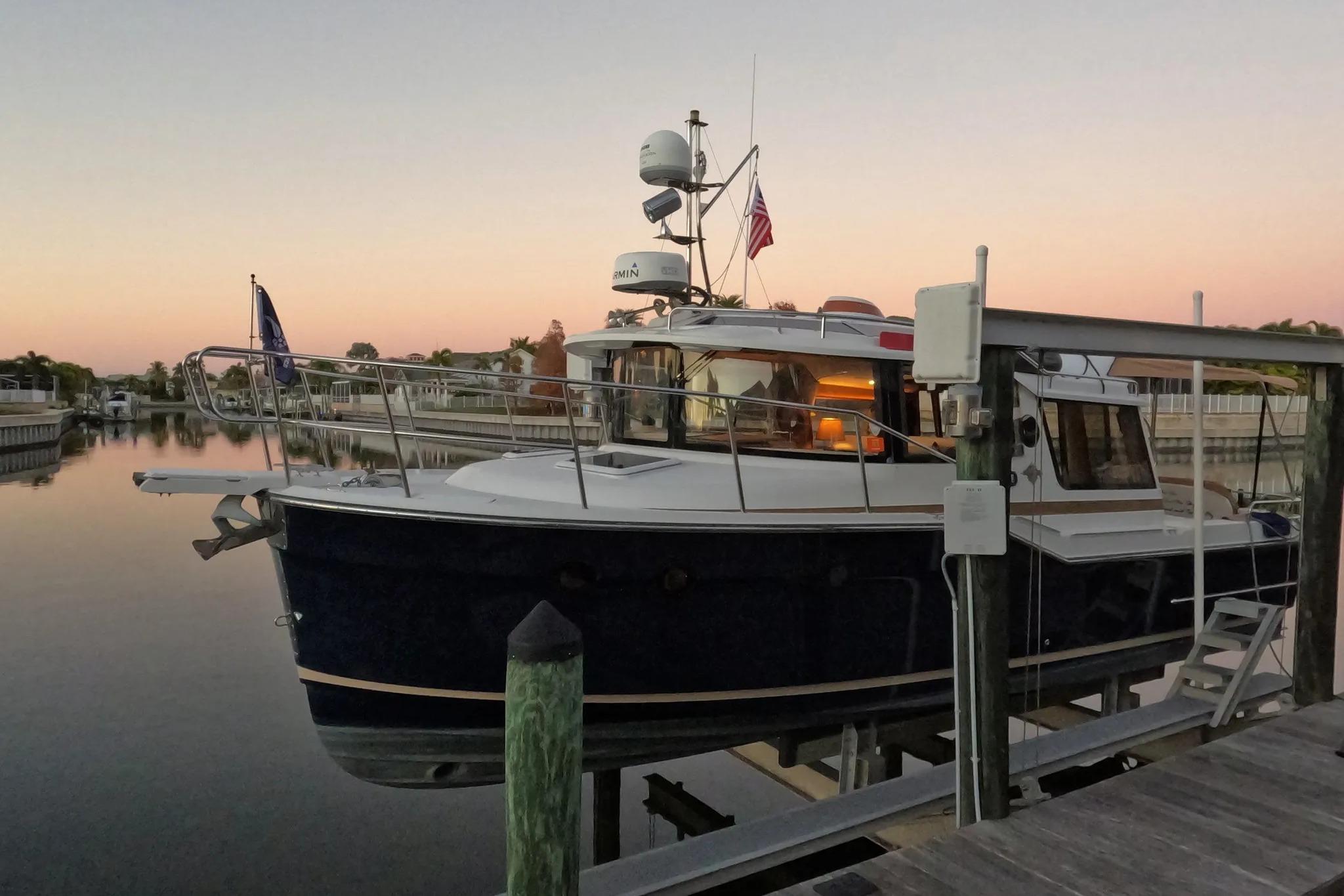2015 Ranger Tugs R-29 S docked at sunset, reflecting on calm waters.