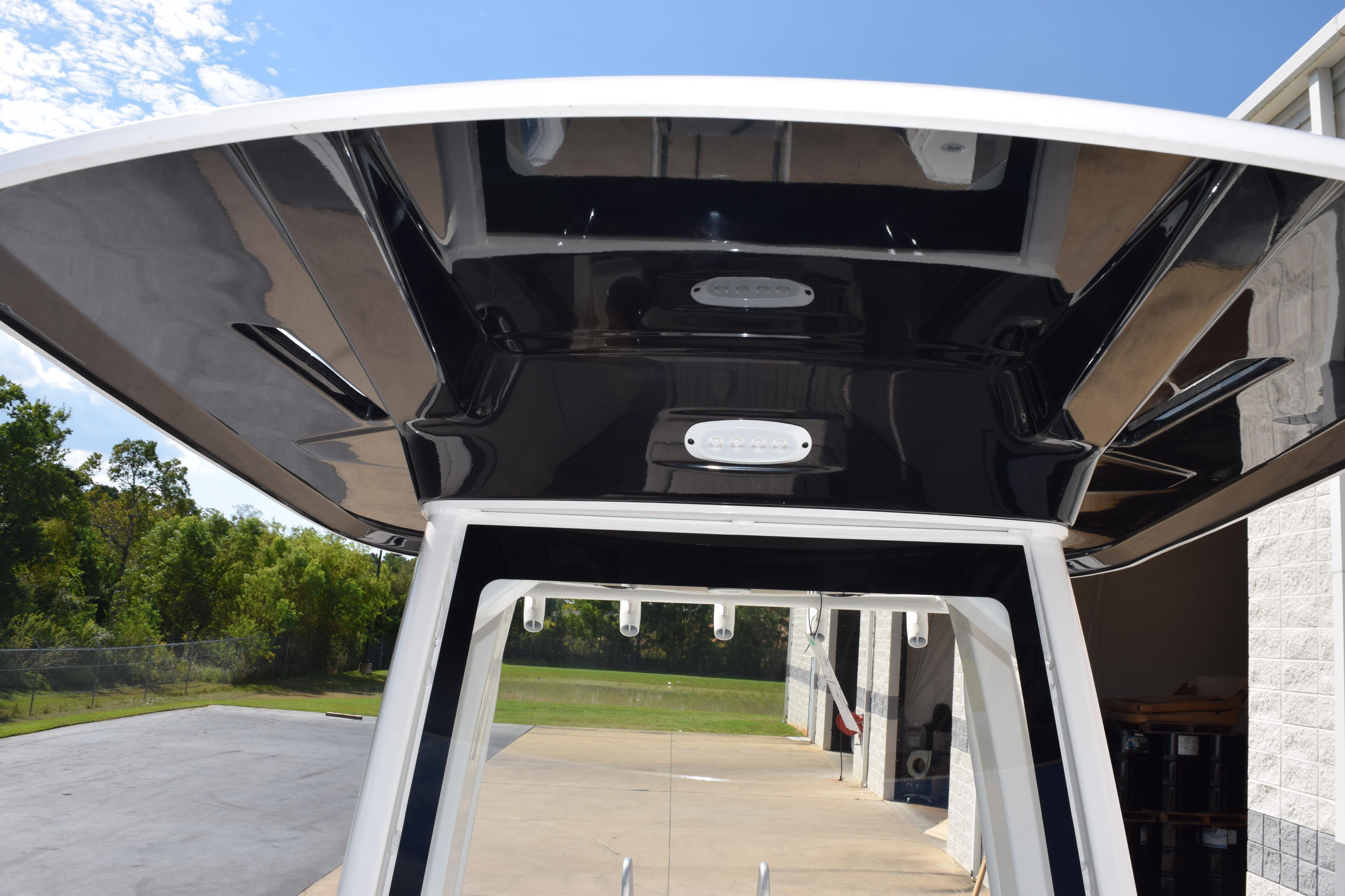 2026 Yamaha Boats 255 FSH Sport H T-top, sleek design, outdoor setting.