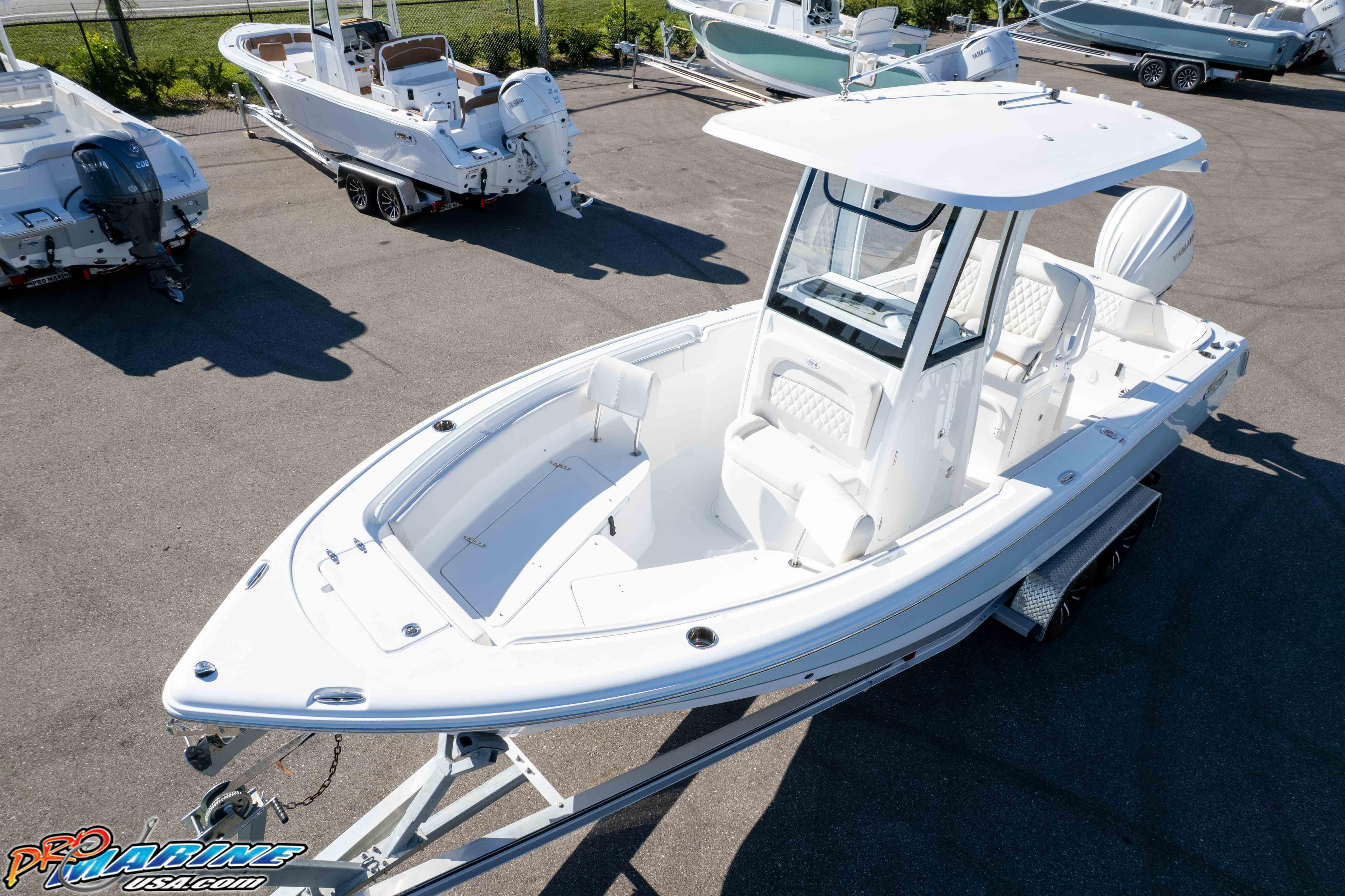 2025 Sea Hunt Ultra 245 SE boat on trailer in marina lot.