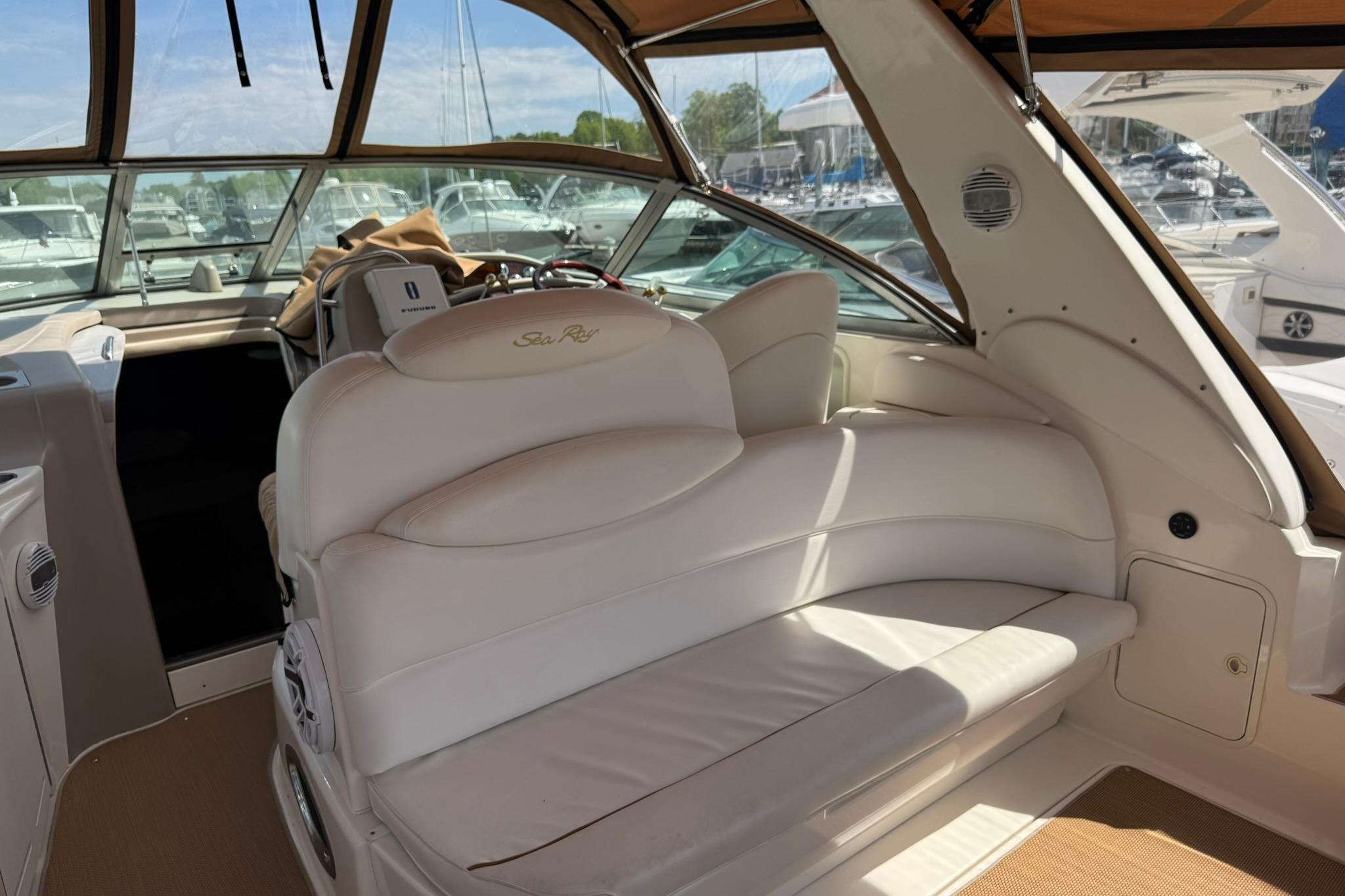 Interior of 2001 Sea Ray 340 Sundancer yacht with white seating and helm.