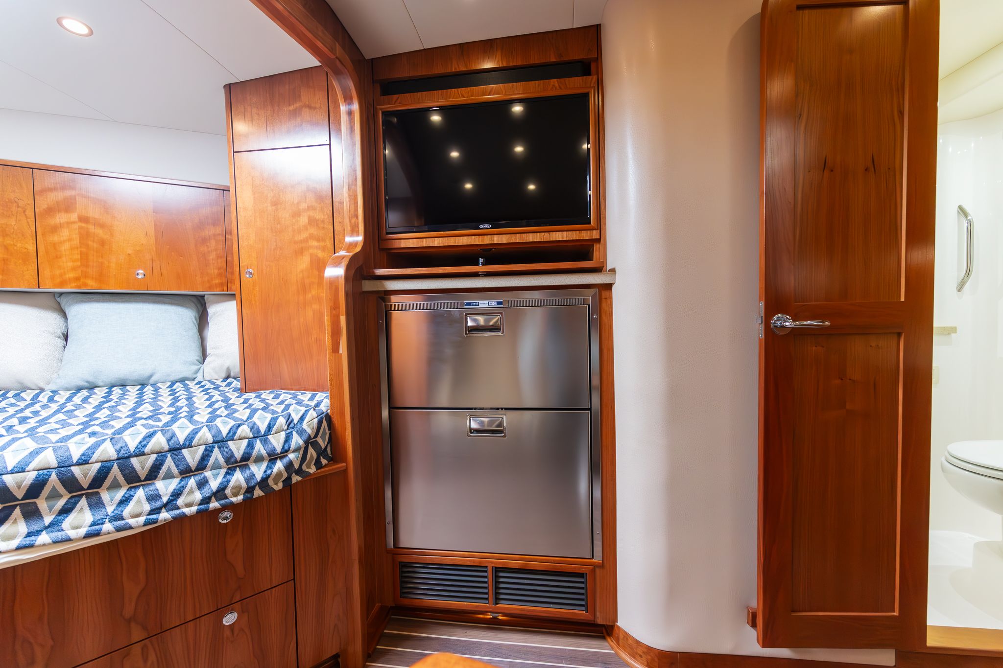 Interior of 2022 Albemarle 36 Express with bed, TV, and cabinets.