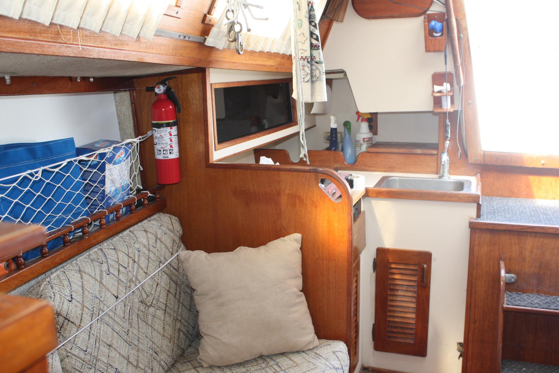 Interior of a 1981 S2 9.2A sailboat featuring a cozy cabin and kitchenette.