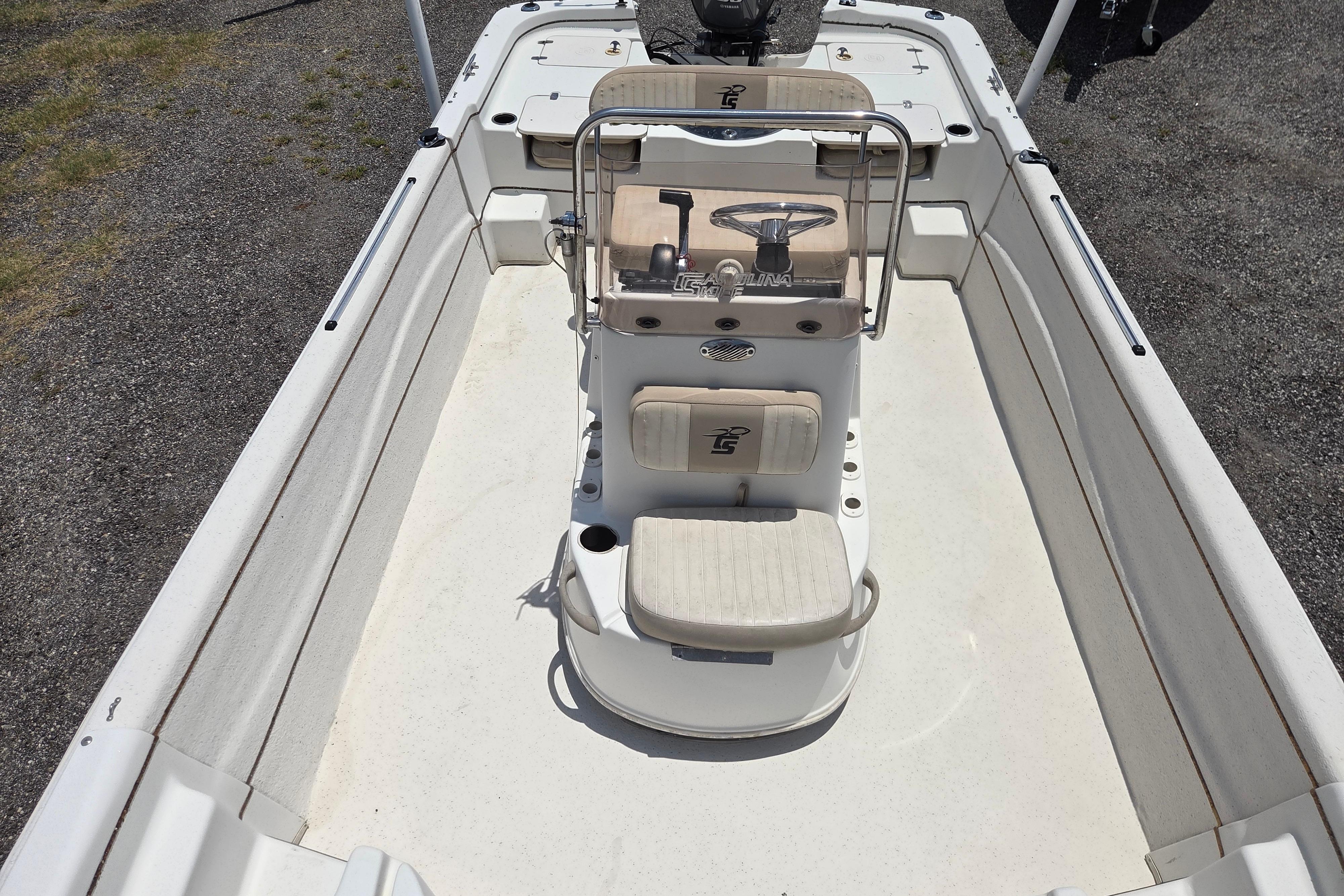 2016 Carolina Skiff 198 DLV boat interior with steering console and seating.