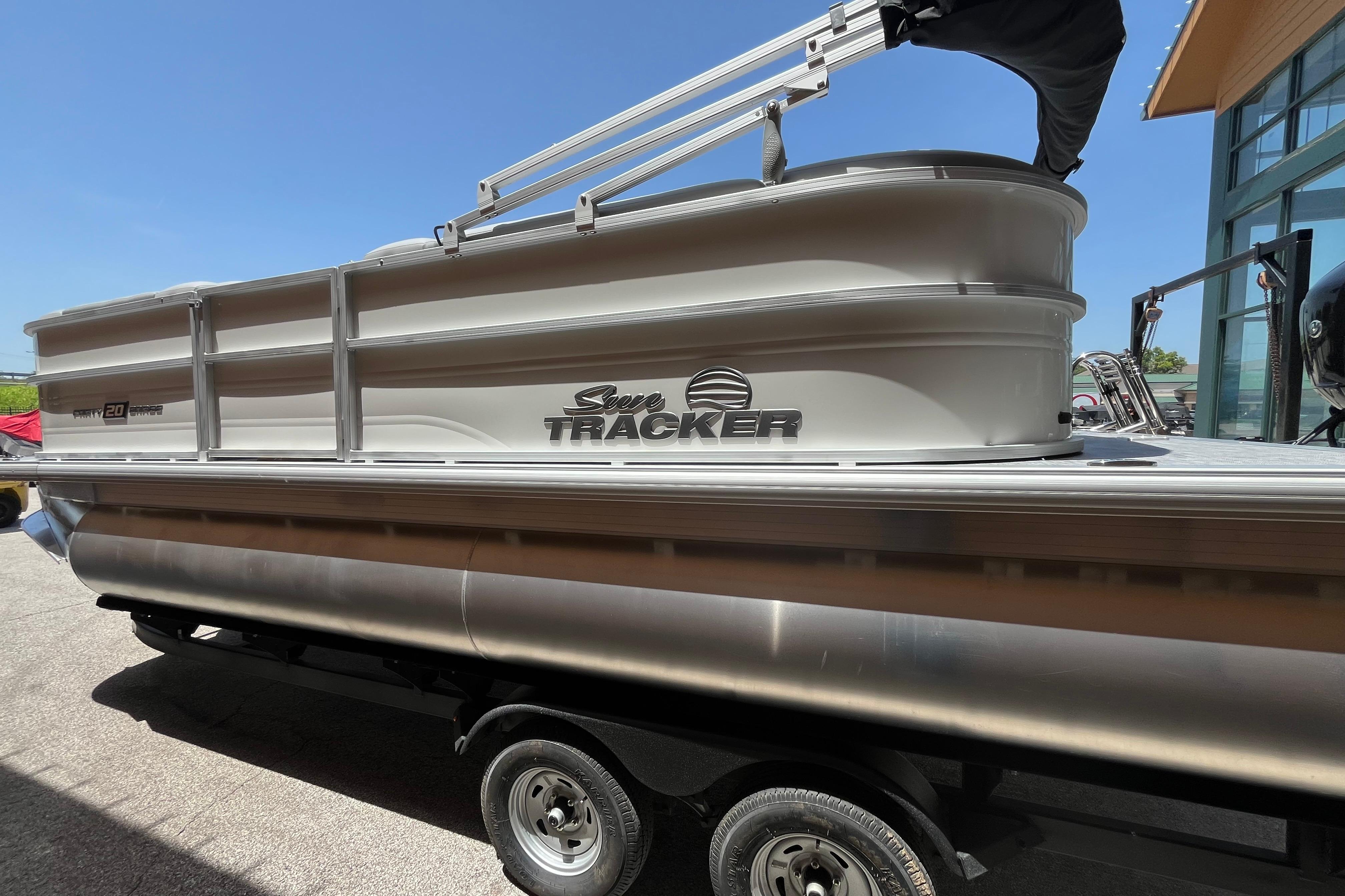 2026 Sun Tracker Party Barge 20 DLX pontoon boat on trailer, side view.