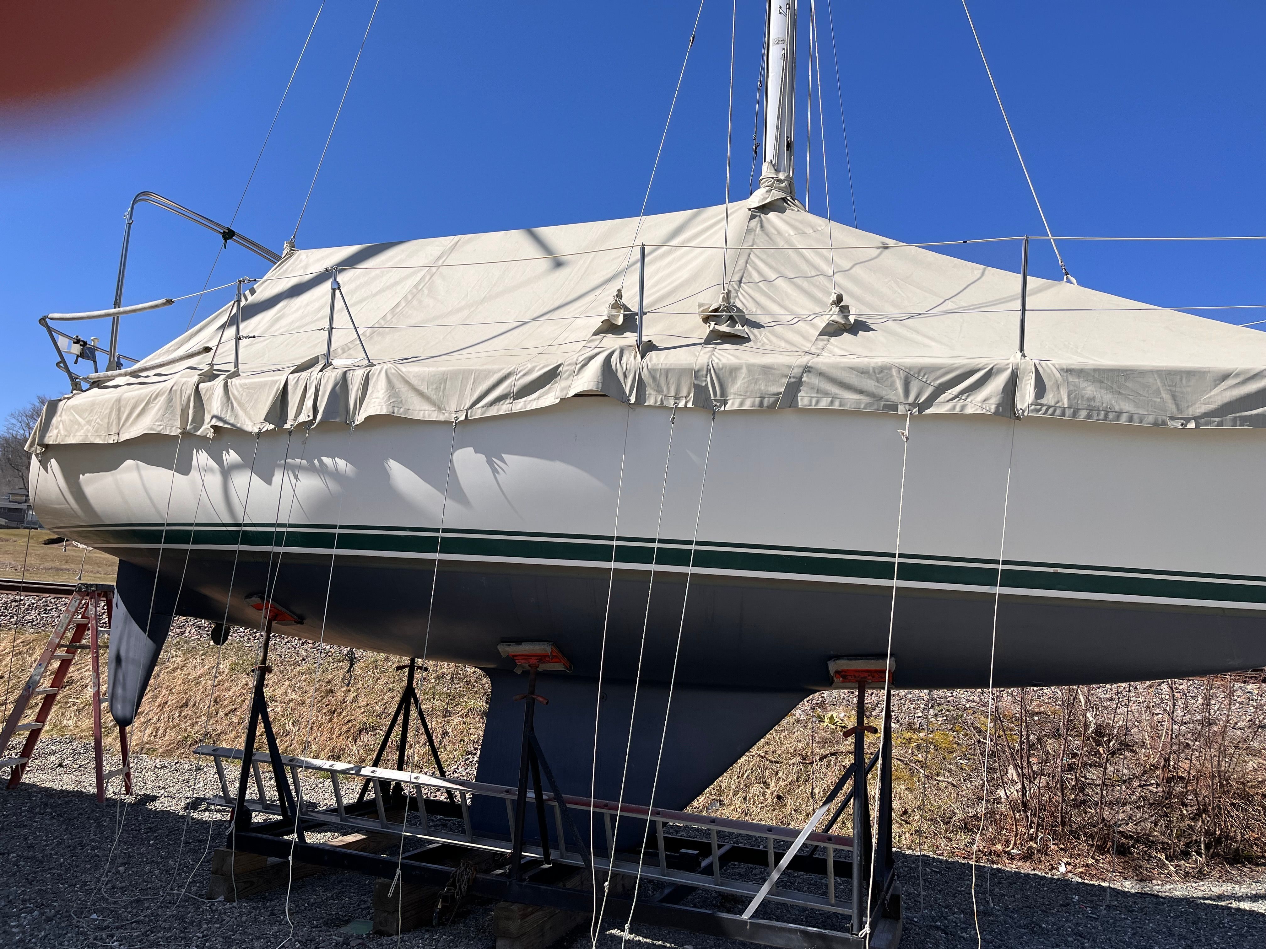 1989 Sabre 30 III sailboat on a stand, covered.