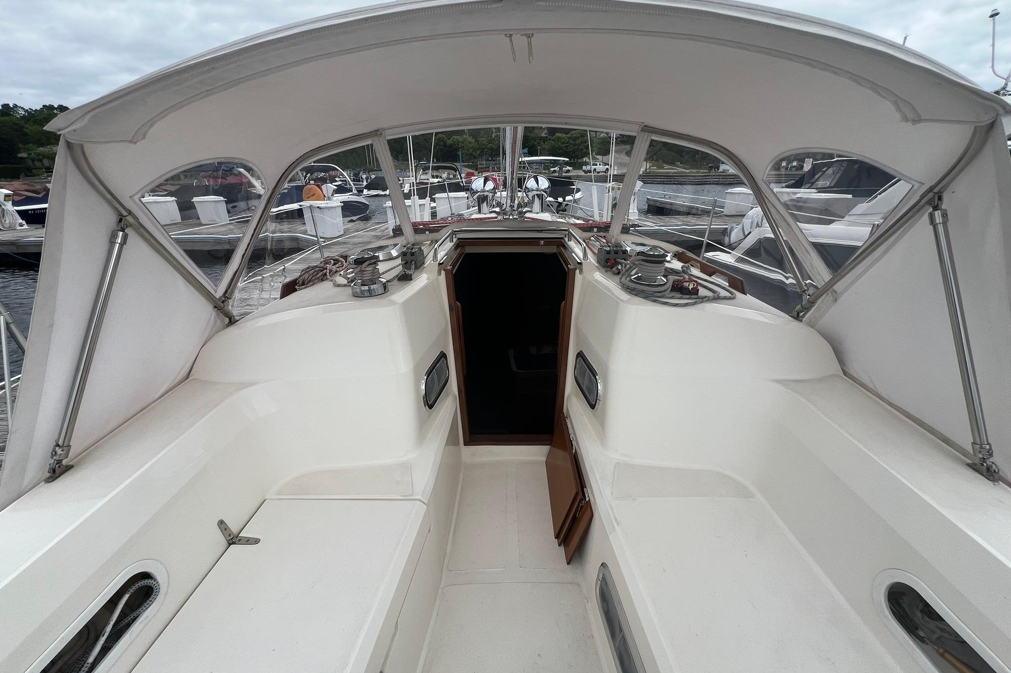 Cockpit of a 1998 Sabre 362 sailboat with canopy and marina view.
