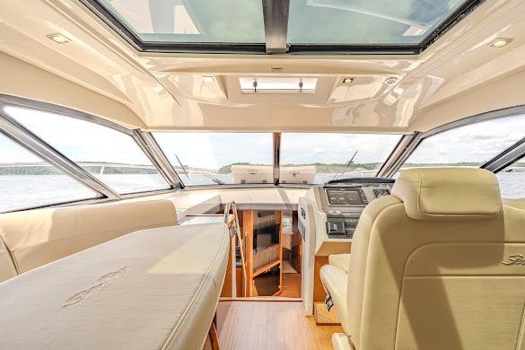 Interior of 2016 Sea Ray Sundancer 510 yacht with luxurious seating and panoramic windows.