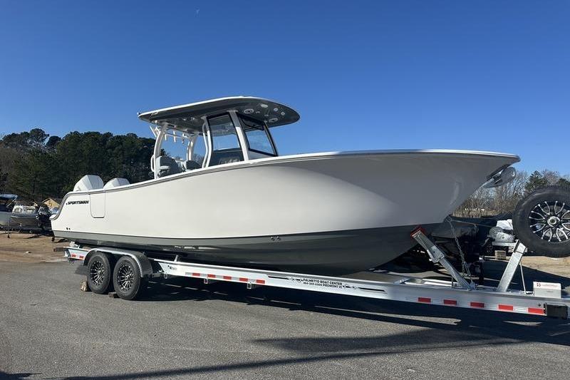 2026 Sportsman Open 282 Center Console boat on trailer under clear blue sky.