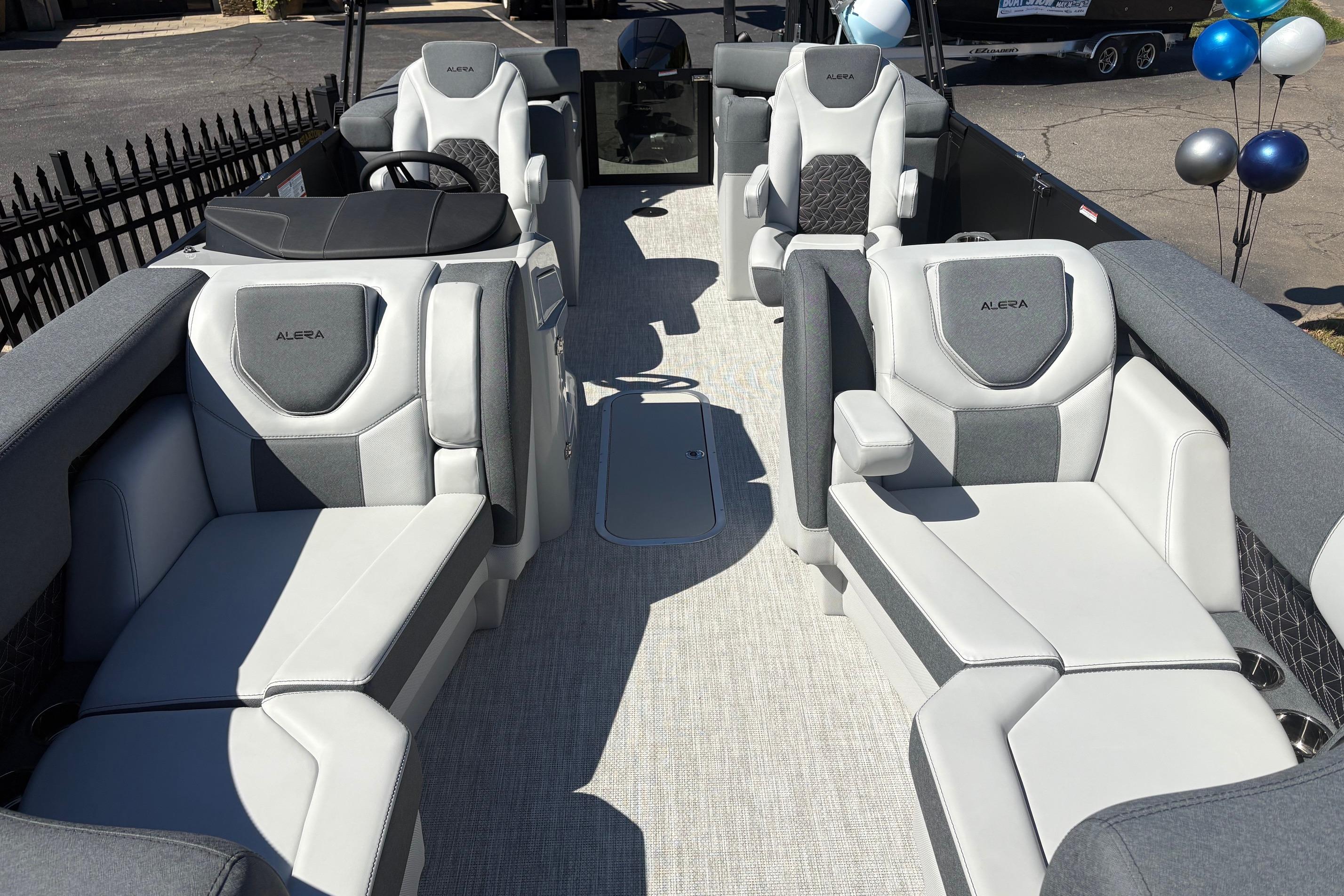 Luxurious interior of 2026 Alera 23Q boat with plush seating and modern design.