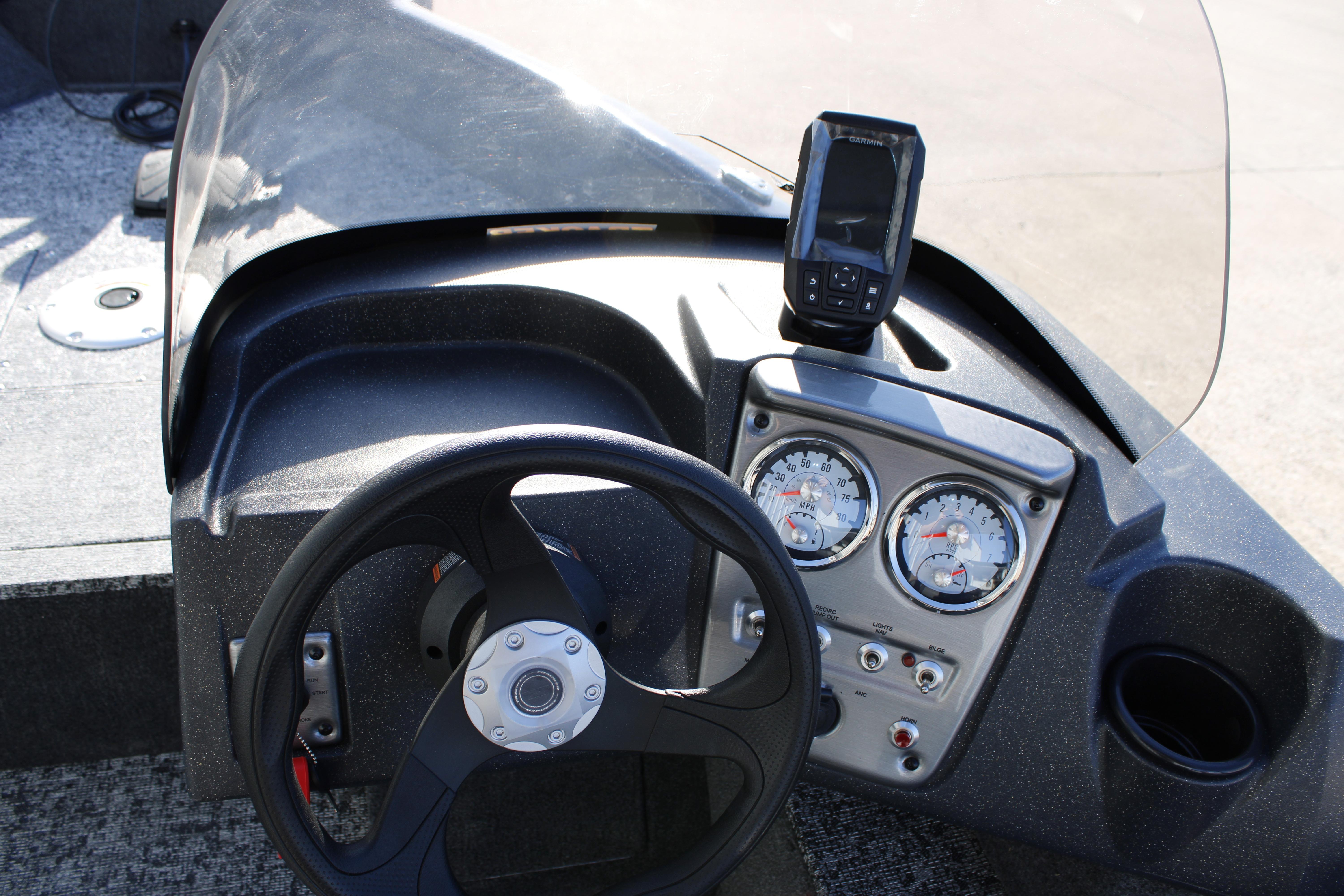 2026 Tracker Pro Guide V-16 SC boat dashboard with steering wheel and gauges.
