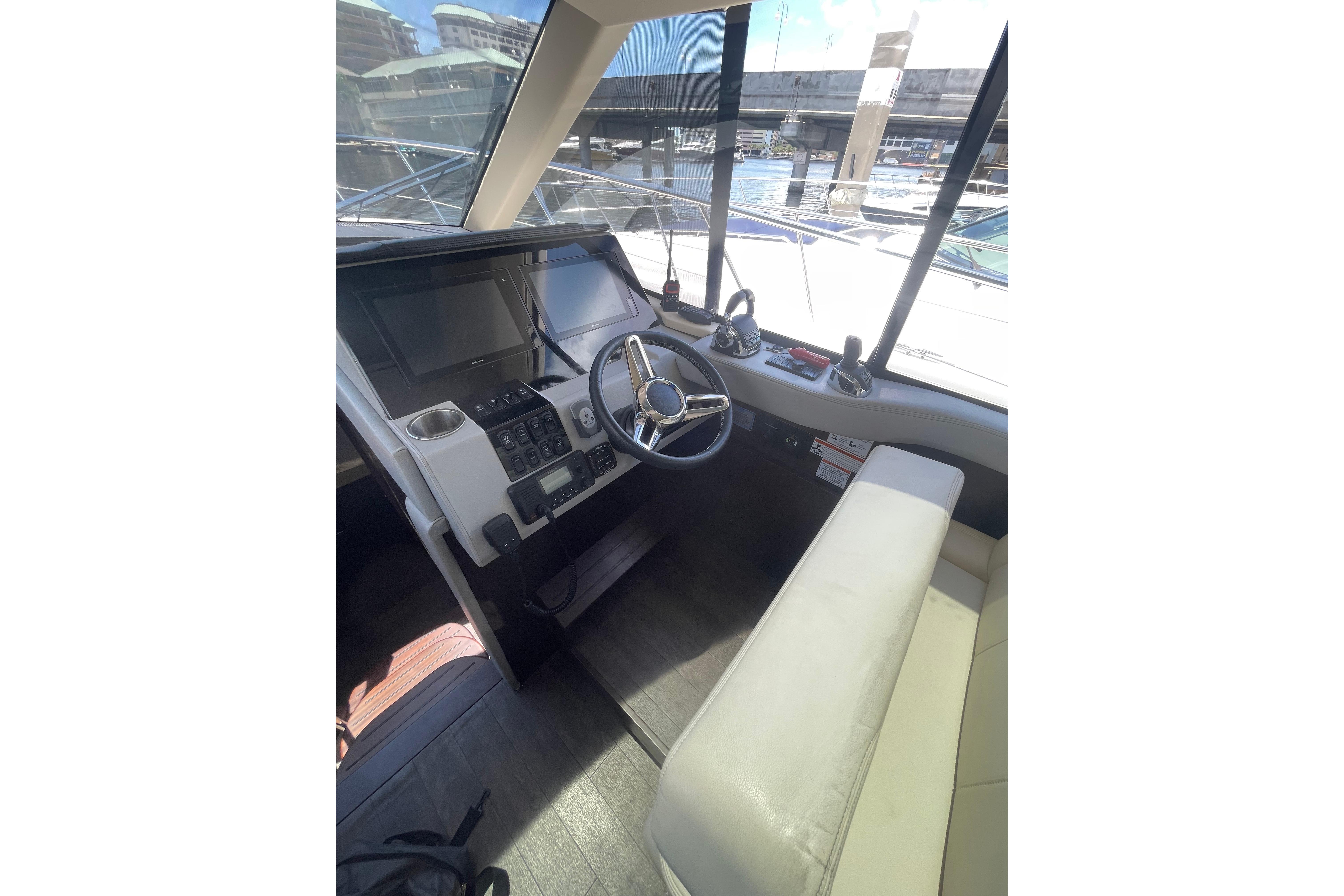 Interior helm of 2020 Regal 42 Grande Coupe yacht with modern controls and seating.