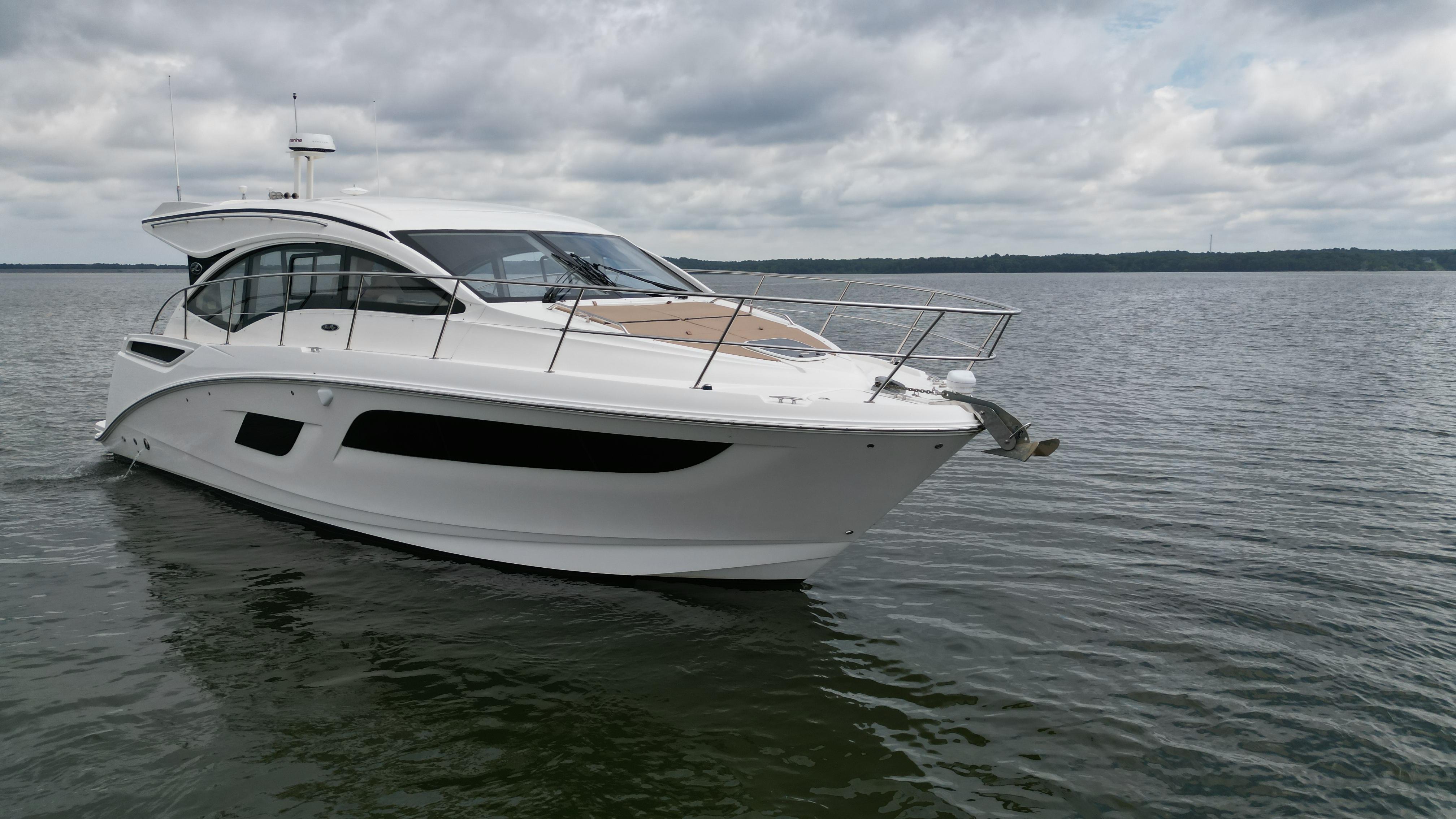 2017 Sea Ray Sundancer 400 yacht cruising on calm waters under cloudy skies.