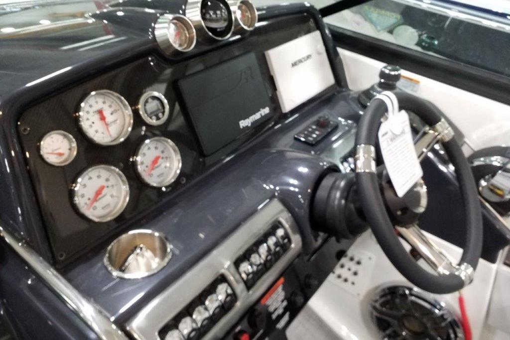 Dashboard of a 2021 Formula 350 Sun Sport boat with gauges and steering wheel.