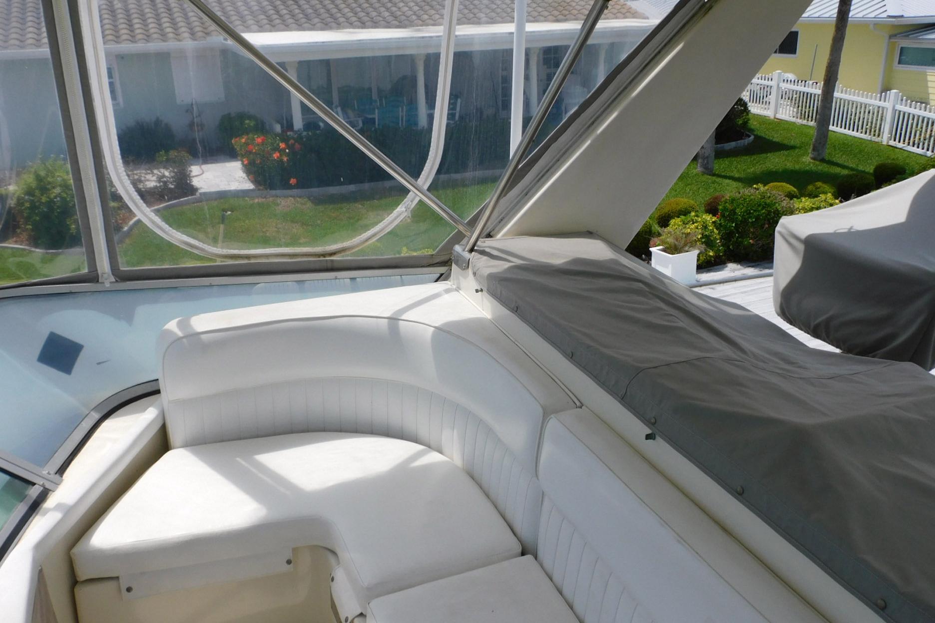 1987 Sea Ray 460 Convertible boat interior with white seating and covered area.