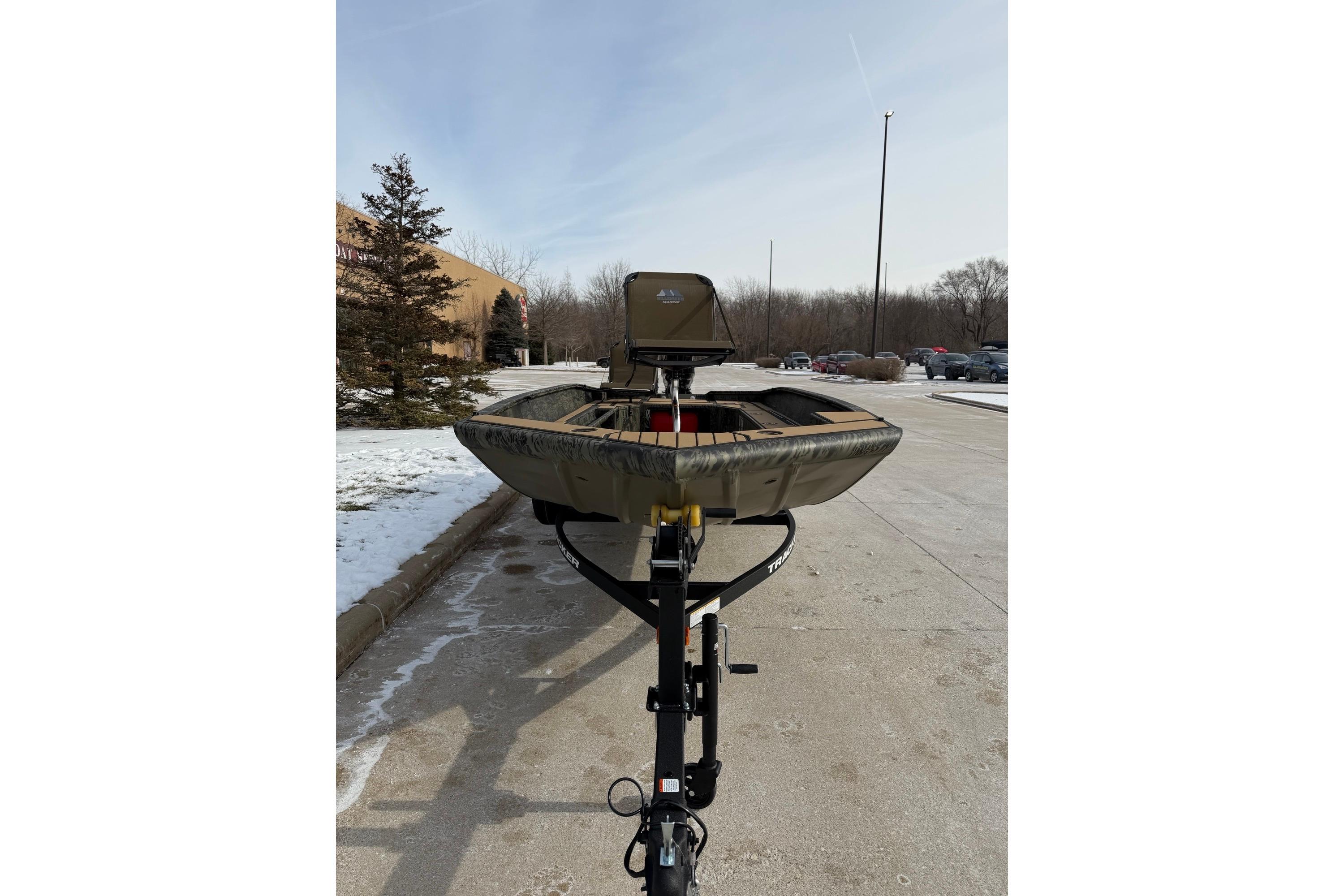 2026 Tracker Grizzly 1756 T Marsh boat on trailer in snowy parking lot.