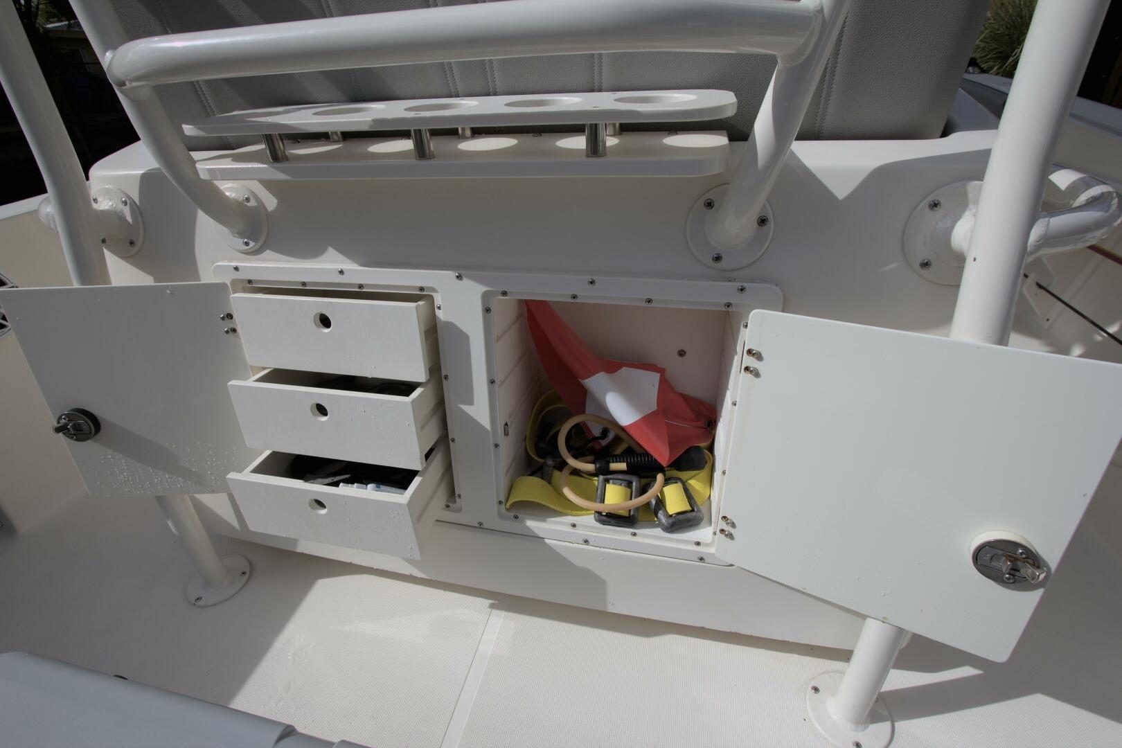 2001 Pursuit 3070 Center Console storage compartments with open doors and visible equipment.