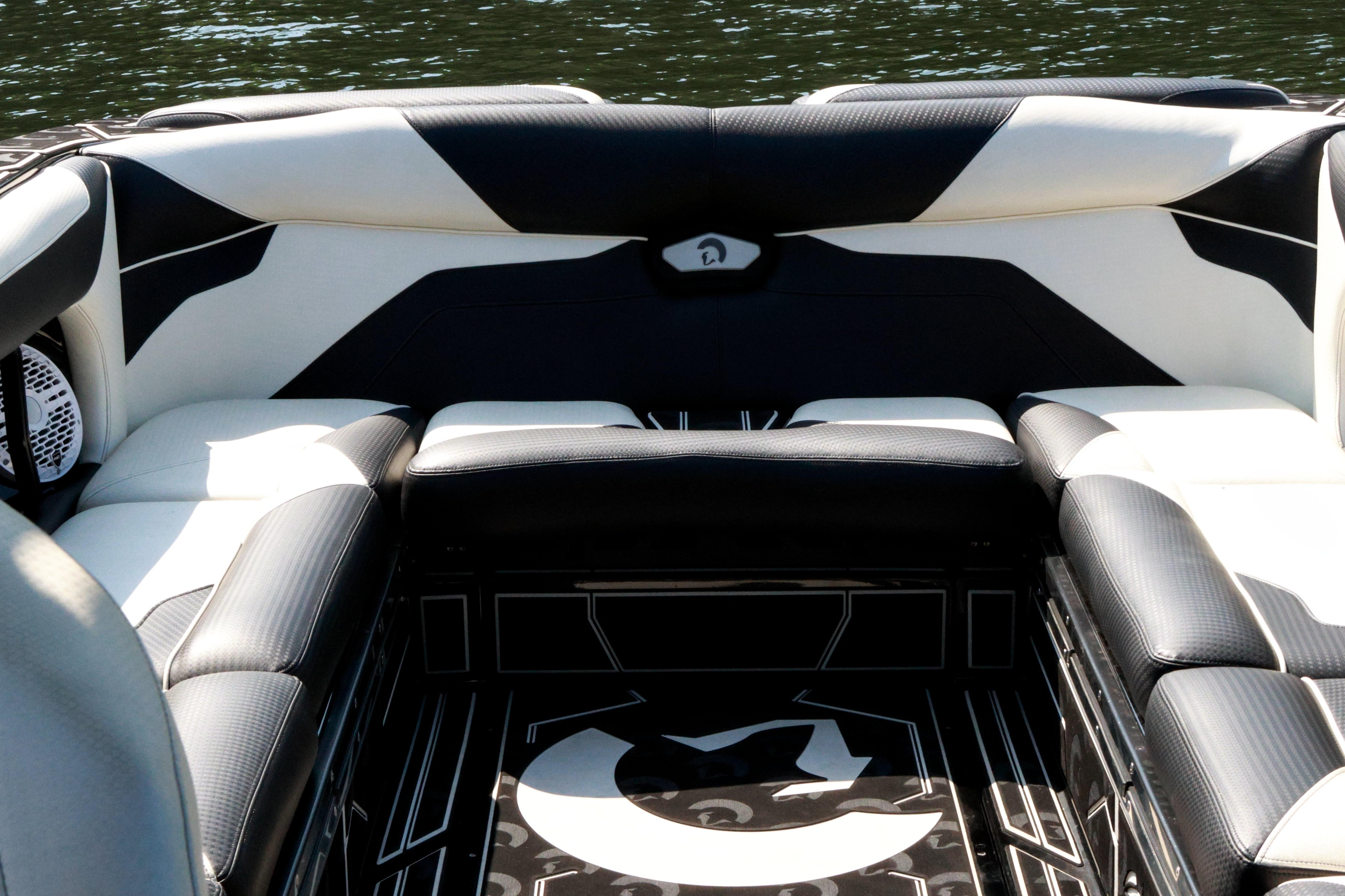 Luxurious seating on 2022 Centurion Ri265 boat, featuring sleek black and white upholstery.