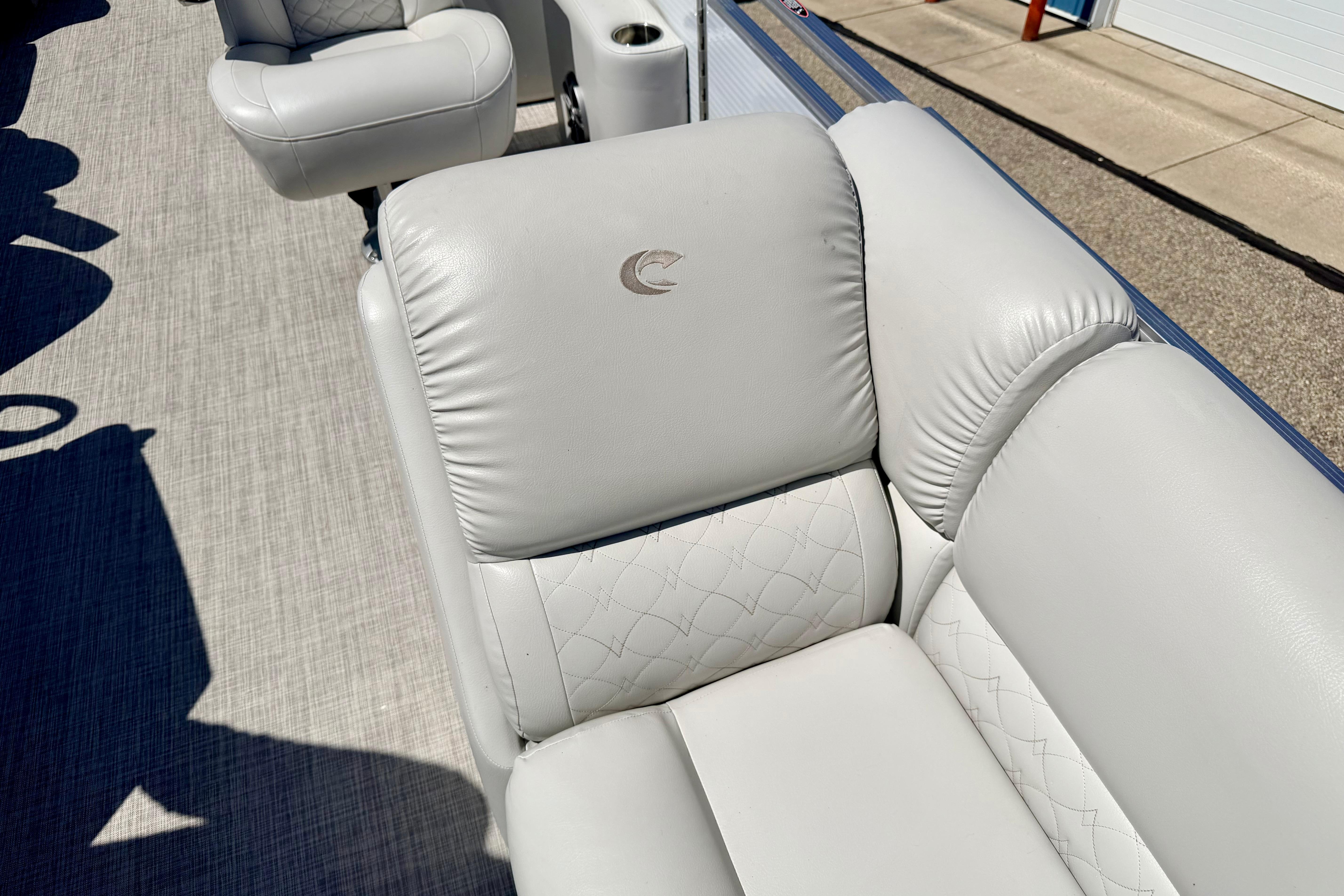 Luxurious seating on 2019 Crestliner 240 Rally DX CW boat, featuring elegant white upholstery.