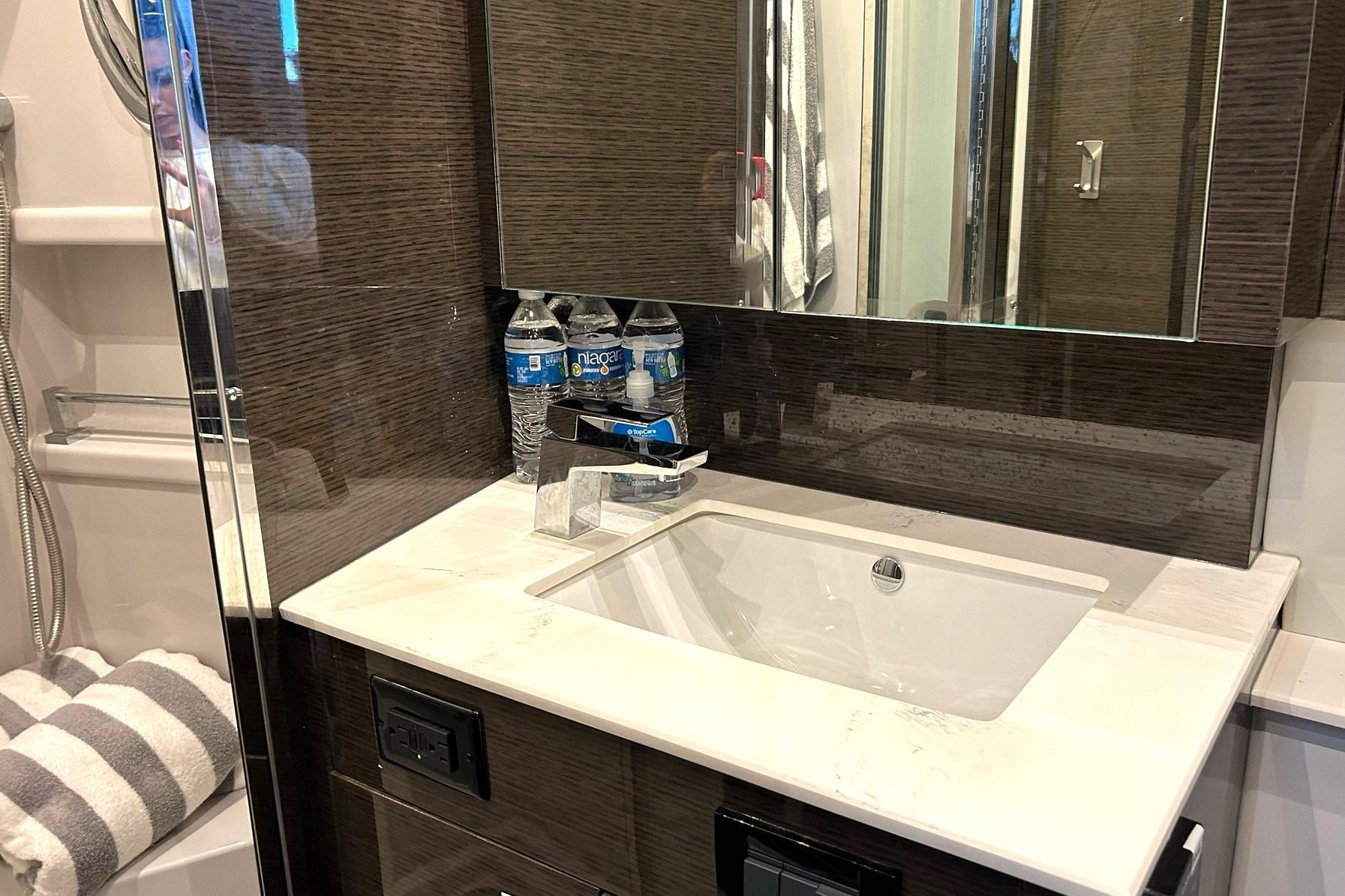 Luxurious bathroom vanity in 2021 Cruisers Yachts 50 Cantius with modern sink and mirror.