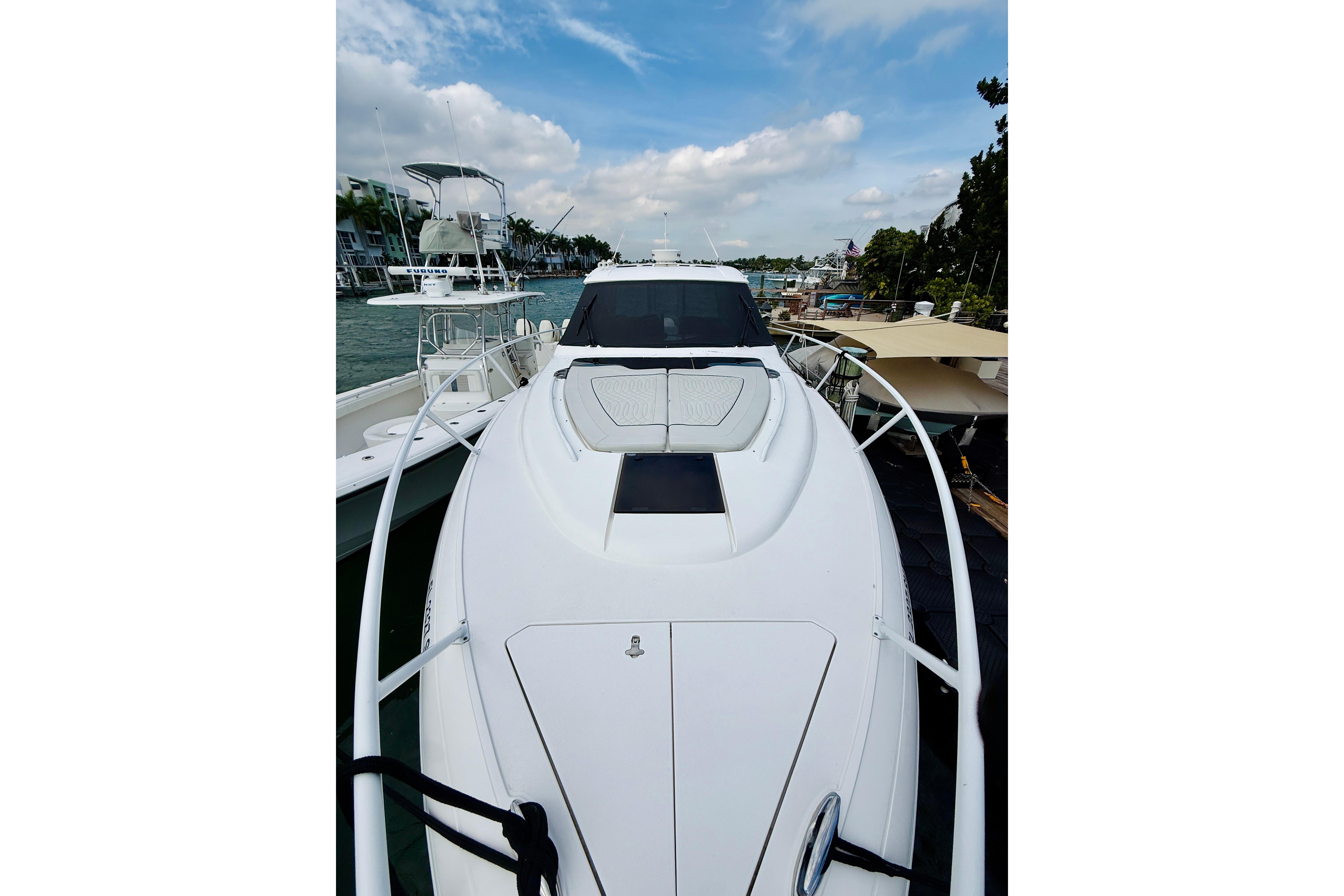 2021 Intrepid 410 Evolution yacht docked, showcasing sleek design and spacious deck.
