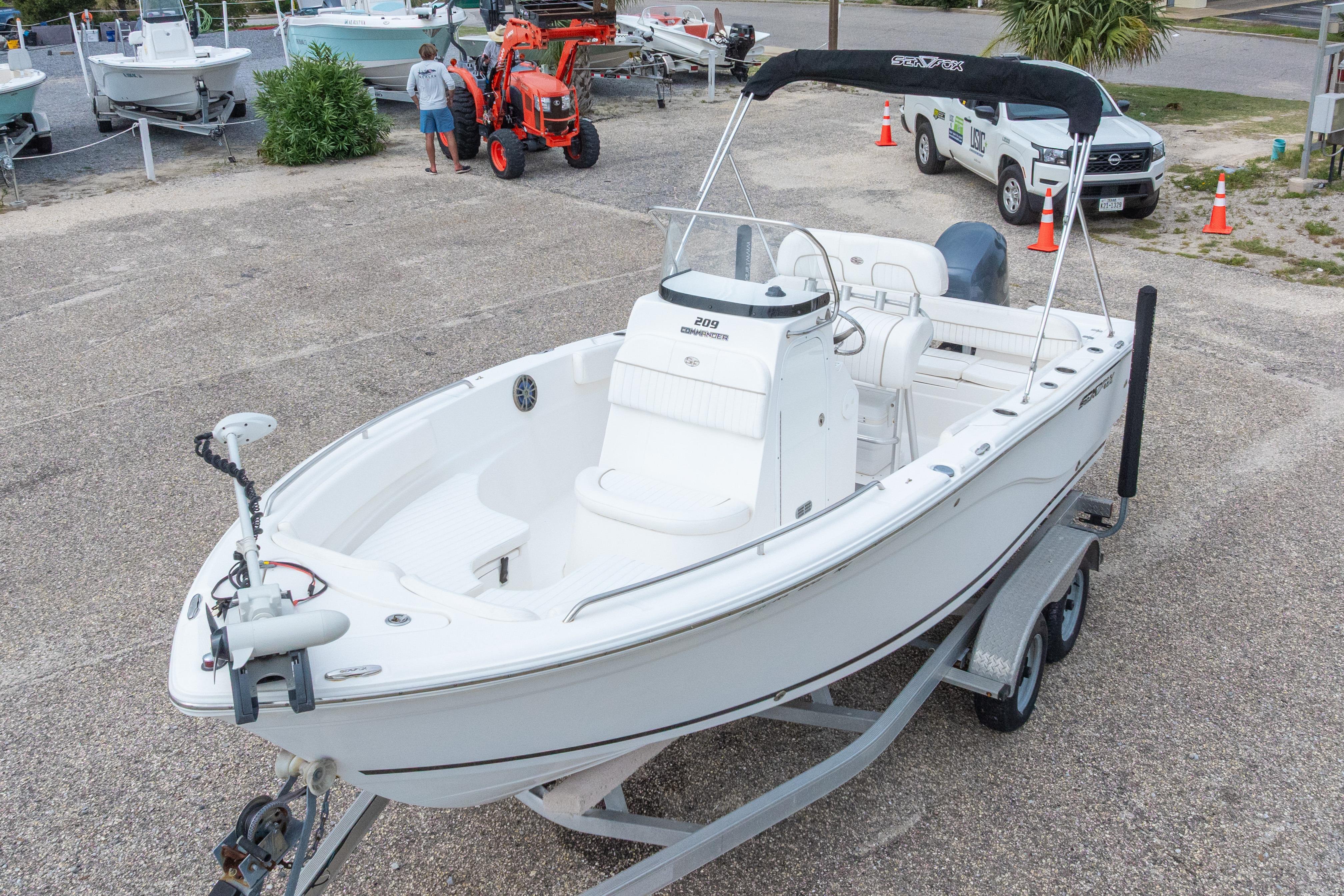 2014 Sea Fox 209 Commander boat on trailer in parking lot, ready for transport.
