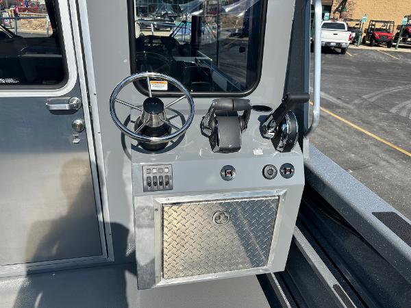 2024 Spartan 260 Maximus Pro XL boat control panel with steering wheel and throttle levers.