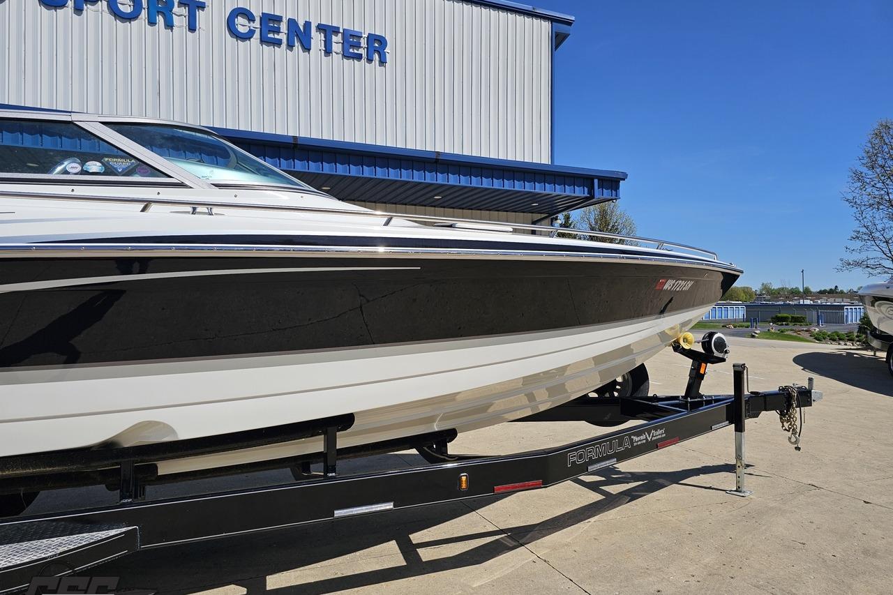 2014 Formula 292 FASTech boat on trailer at a sport center, sunny day.