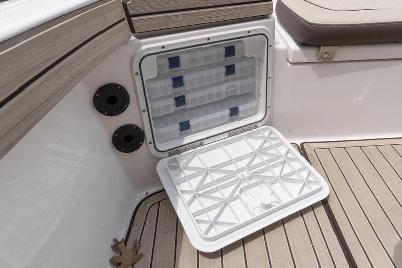 2023 Yamaha Boats 195 FSH Sport storage compartment with open hatch on deck.
