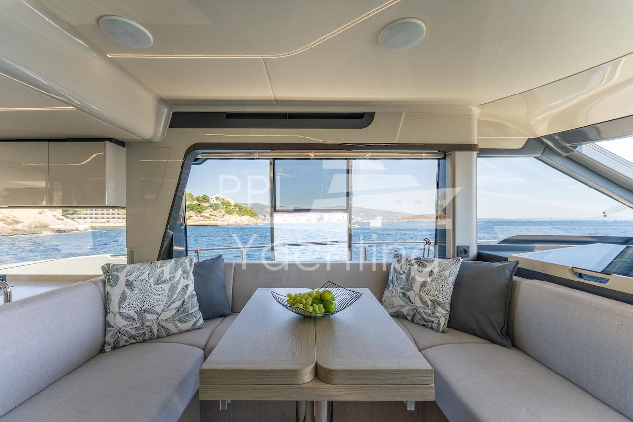 Luxurious interior of 2021 Absolute 47 Fly yacht with elegant seating and sea view.