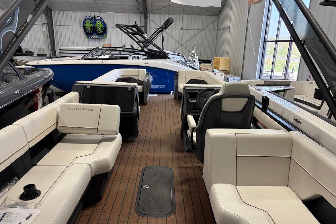 2023 Manitou EXPLORE 26 SHP 575 boat interior with luxurious seating and modern design.