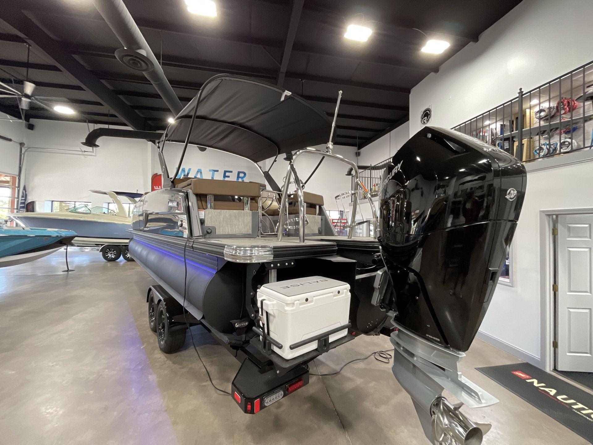 2025 Balise Horizon 26C boat in showroom, featuring powerful outboard motor and sleek design.