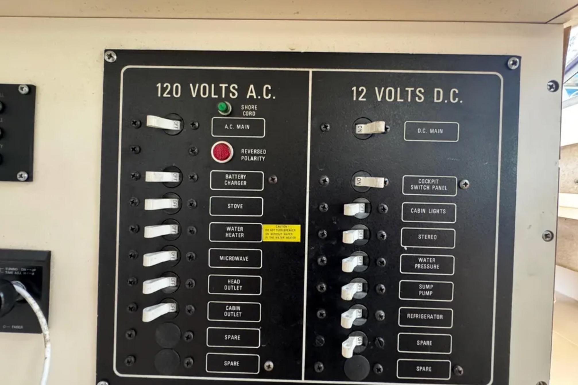 Electrical panel on a 1990 Grady-White Marlin 280 boat, showing AC and DC switches.