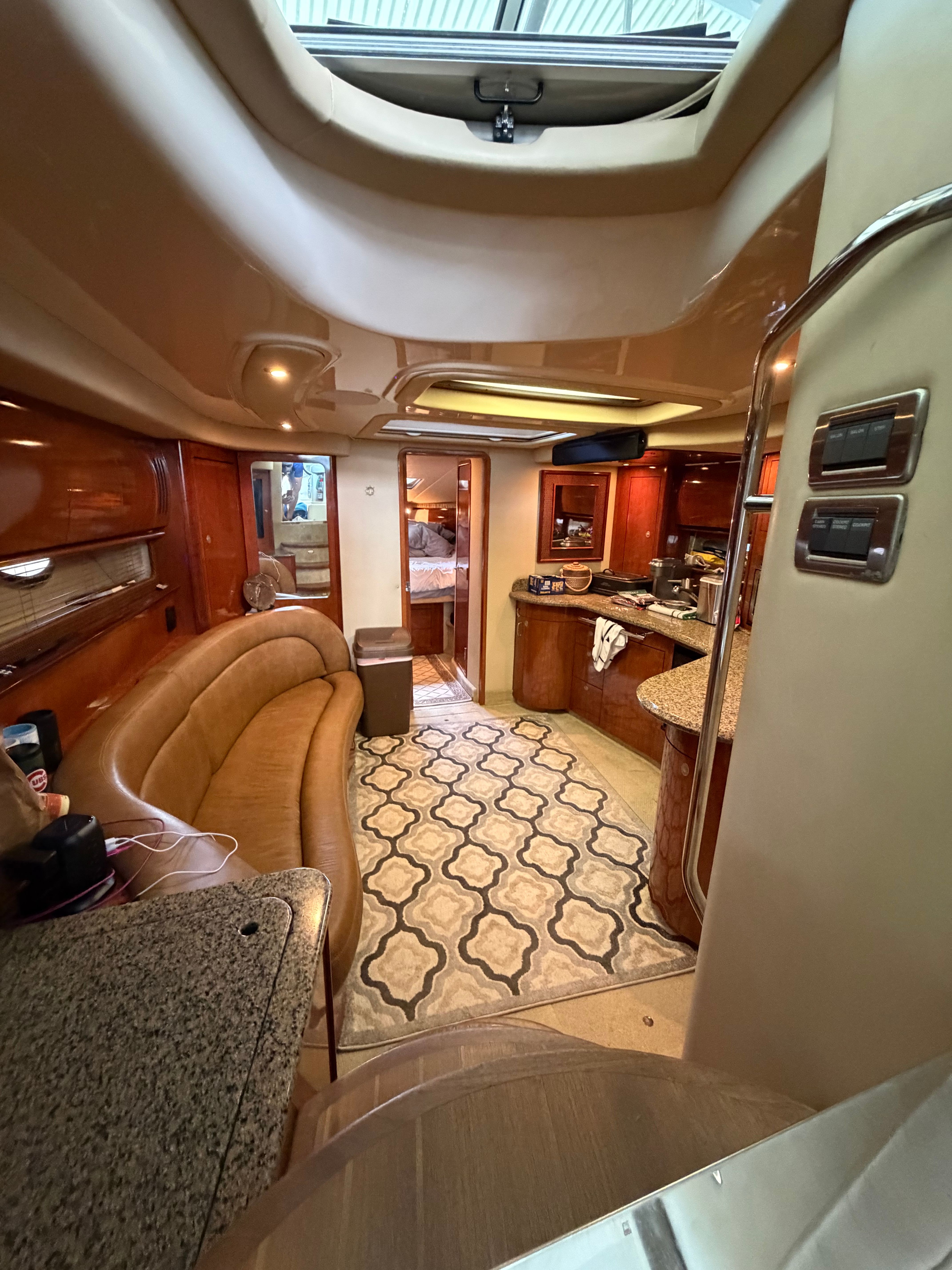 Interior of a 2005 Sea Ray 420DA with elegant furnishings and a modern kitchen.