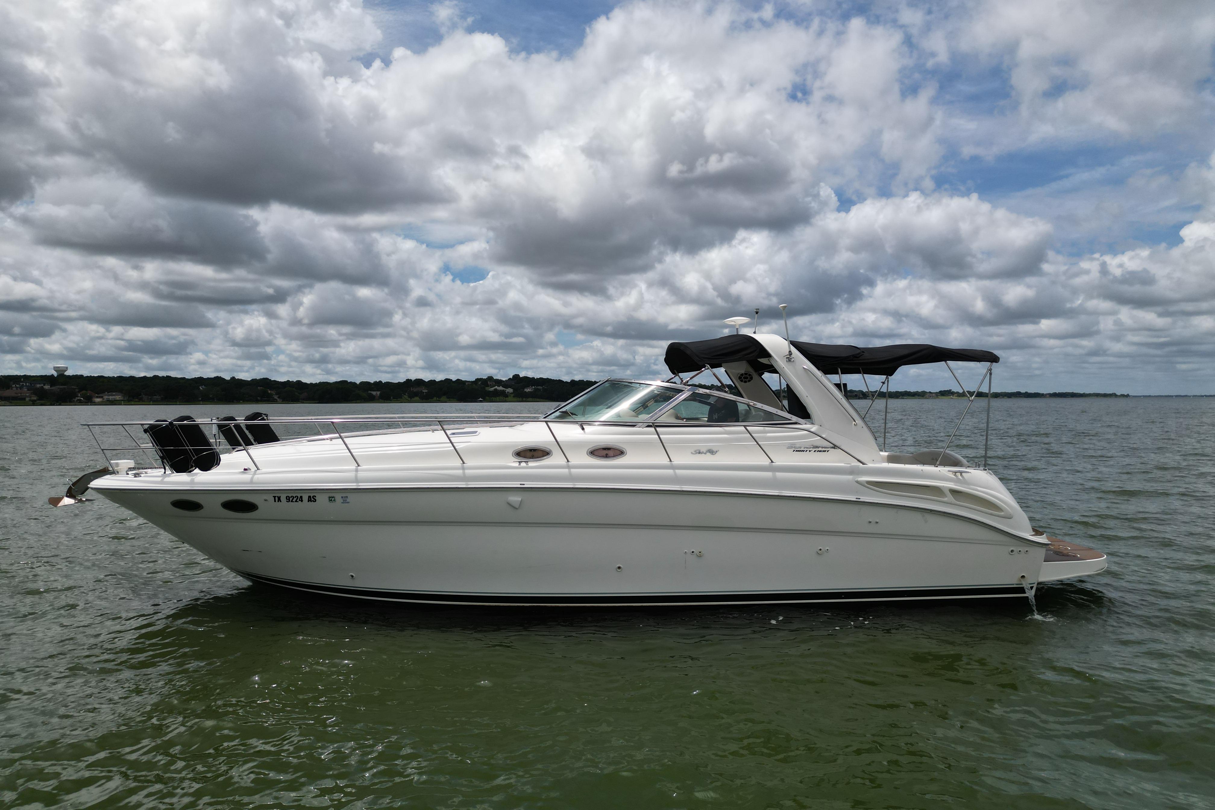 2001 Sea Ray 380 Sundancer yacht on calm water under cloudy sky.