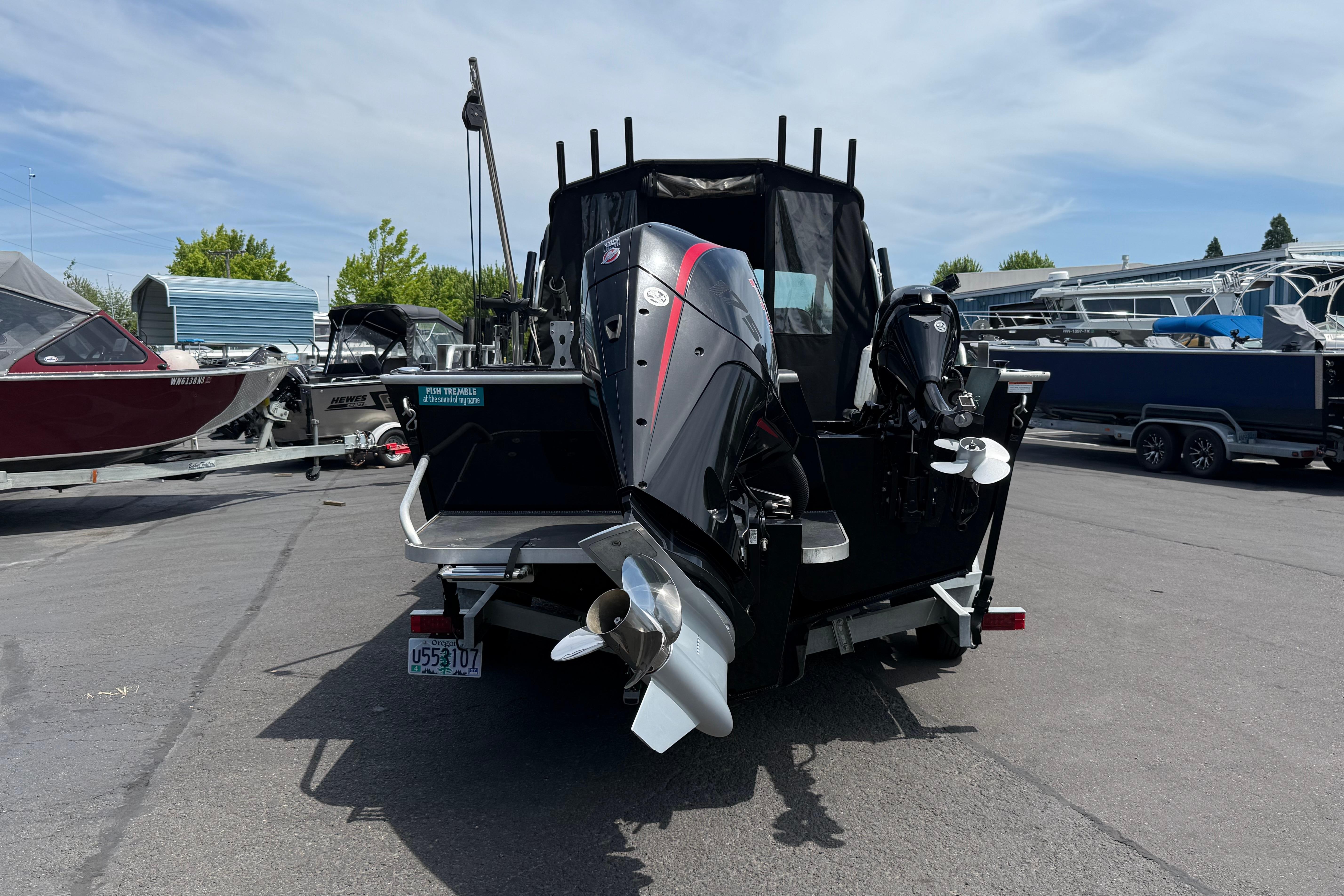 2019 Alumaweld Intruder Hard Top 22' boat with dual outboard motors in a marina.