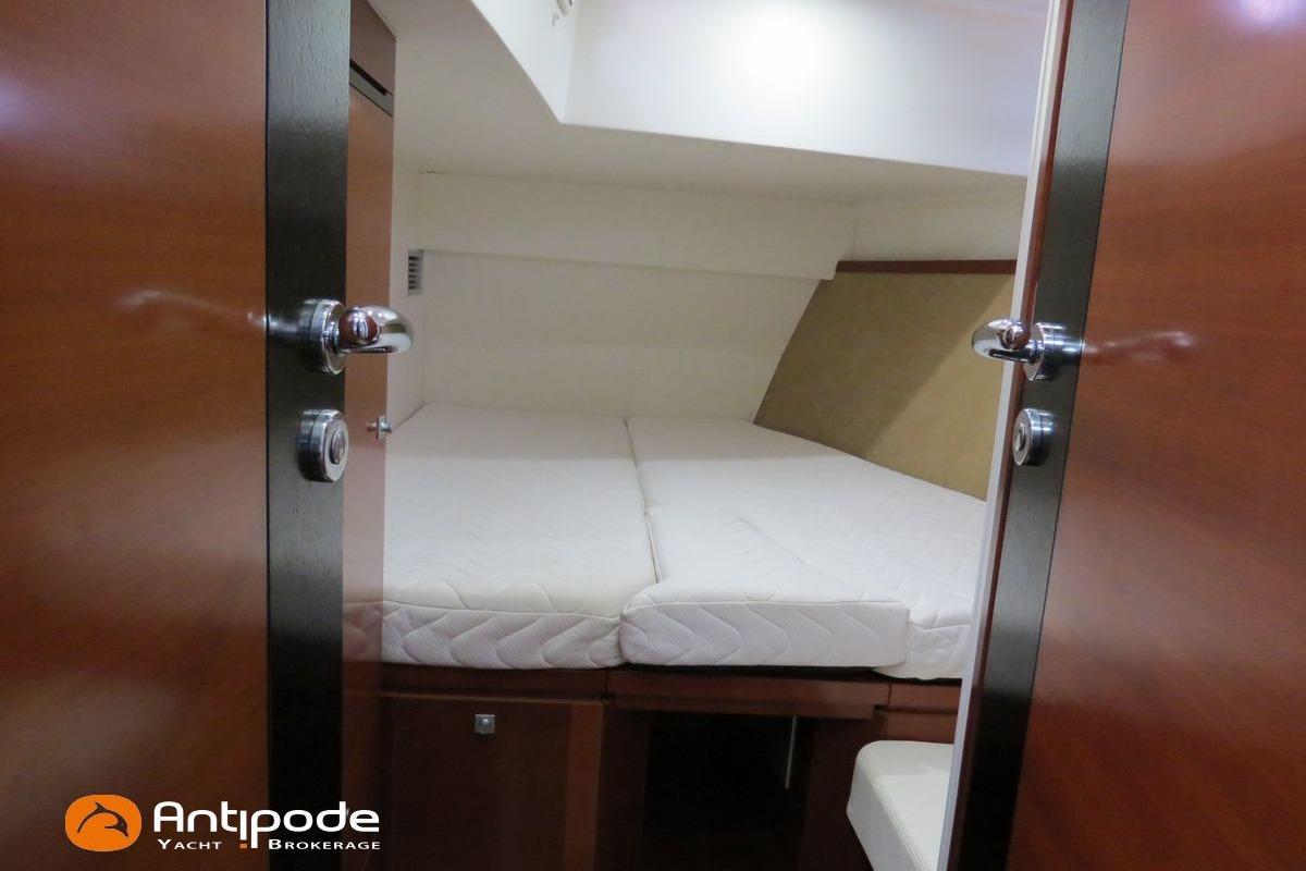 Interior cabin view of 2012 CNB BORDEAUX 60 yacht with cozy bed setup.