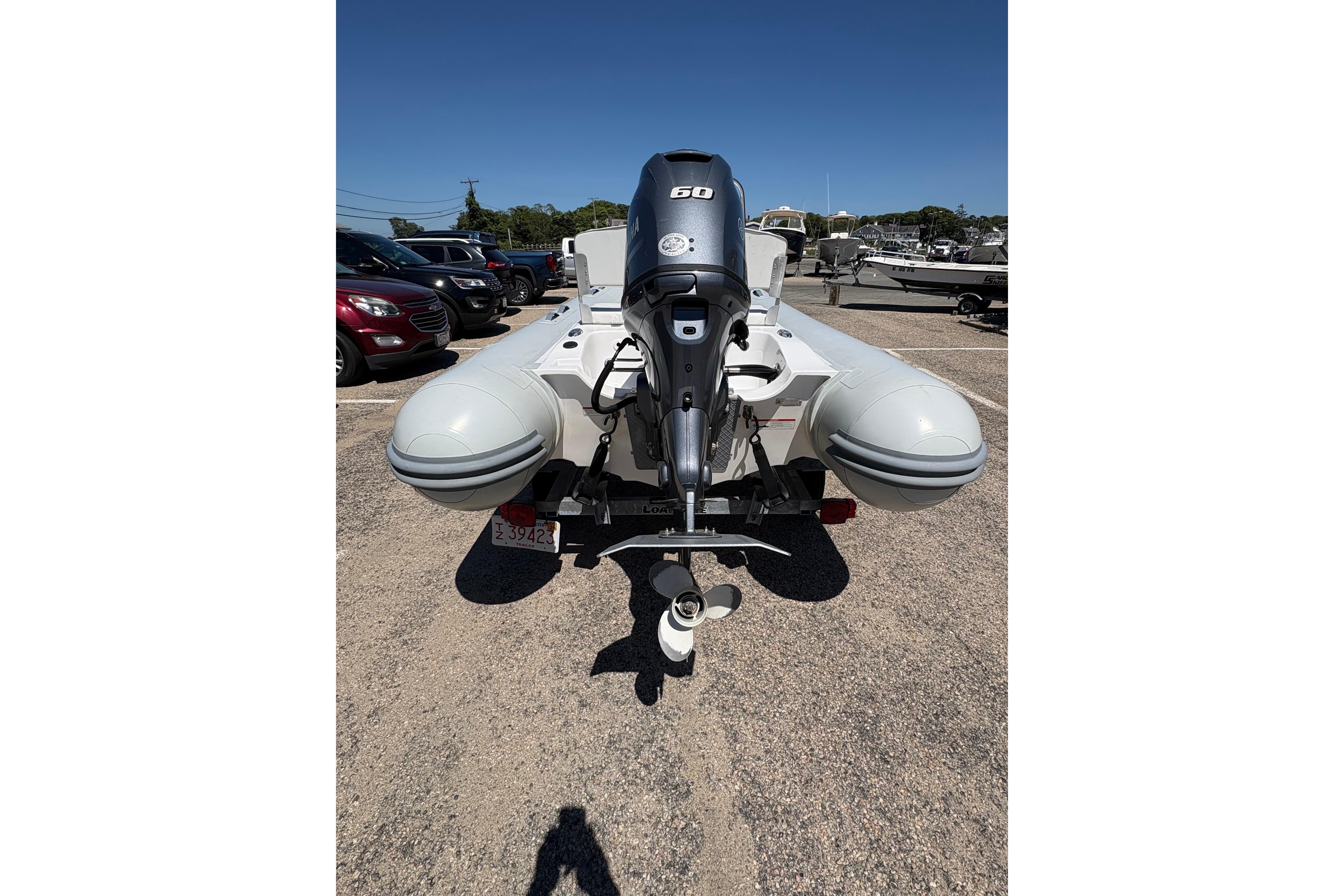 2022 AB Inflatables Oceanus 14 VST boat with outboard motor, parked in a lot.