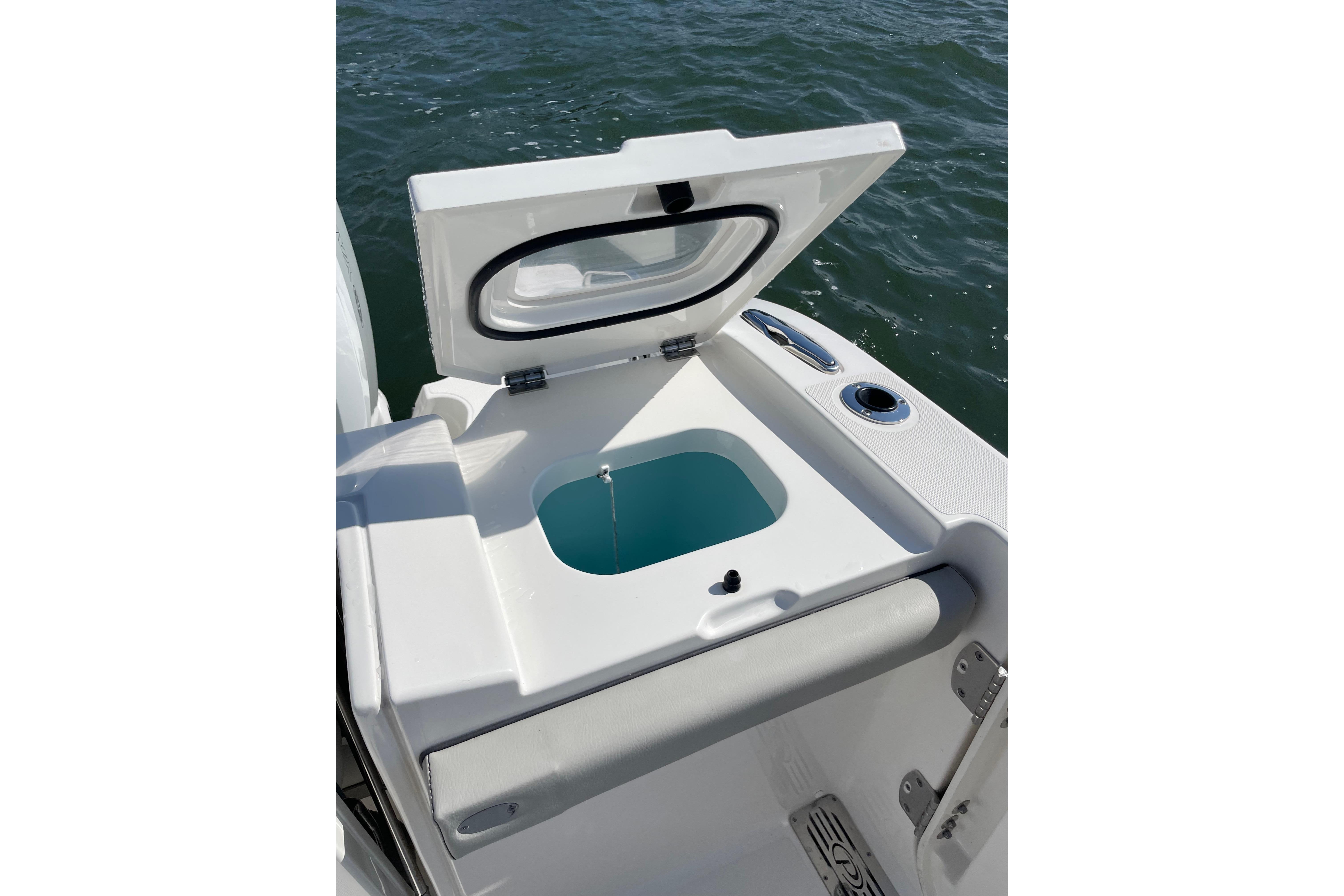 2023 Pursuit S 328 Sport boat with open livewell on deck.