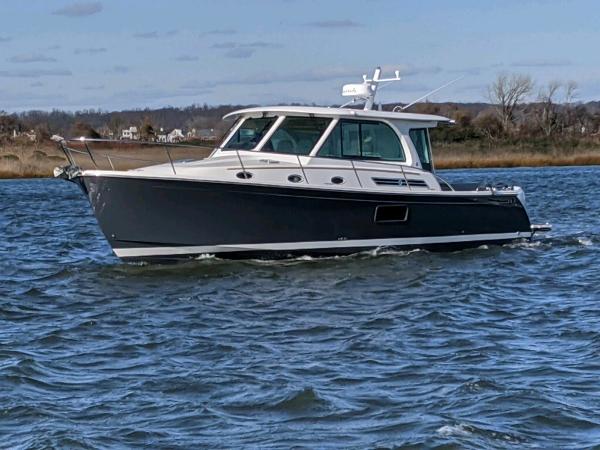 2025 Back Cove 39O boat cruising on a calm lake.