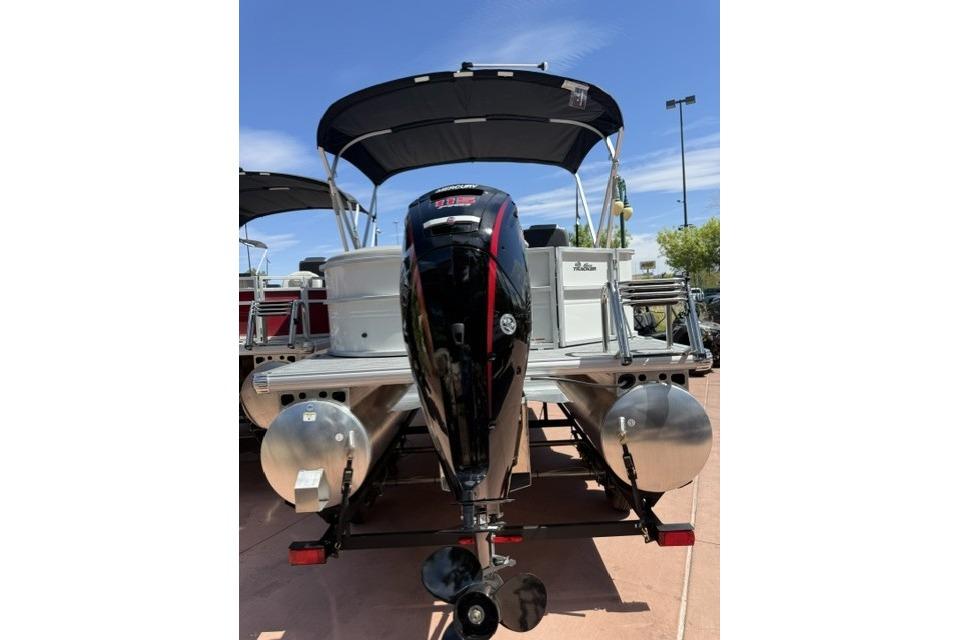 2026 Sun Tracker Party Barge 20 DLX pontoon boat with outboard motor and canopy.