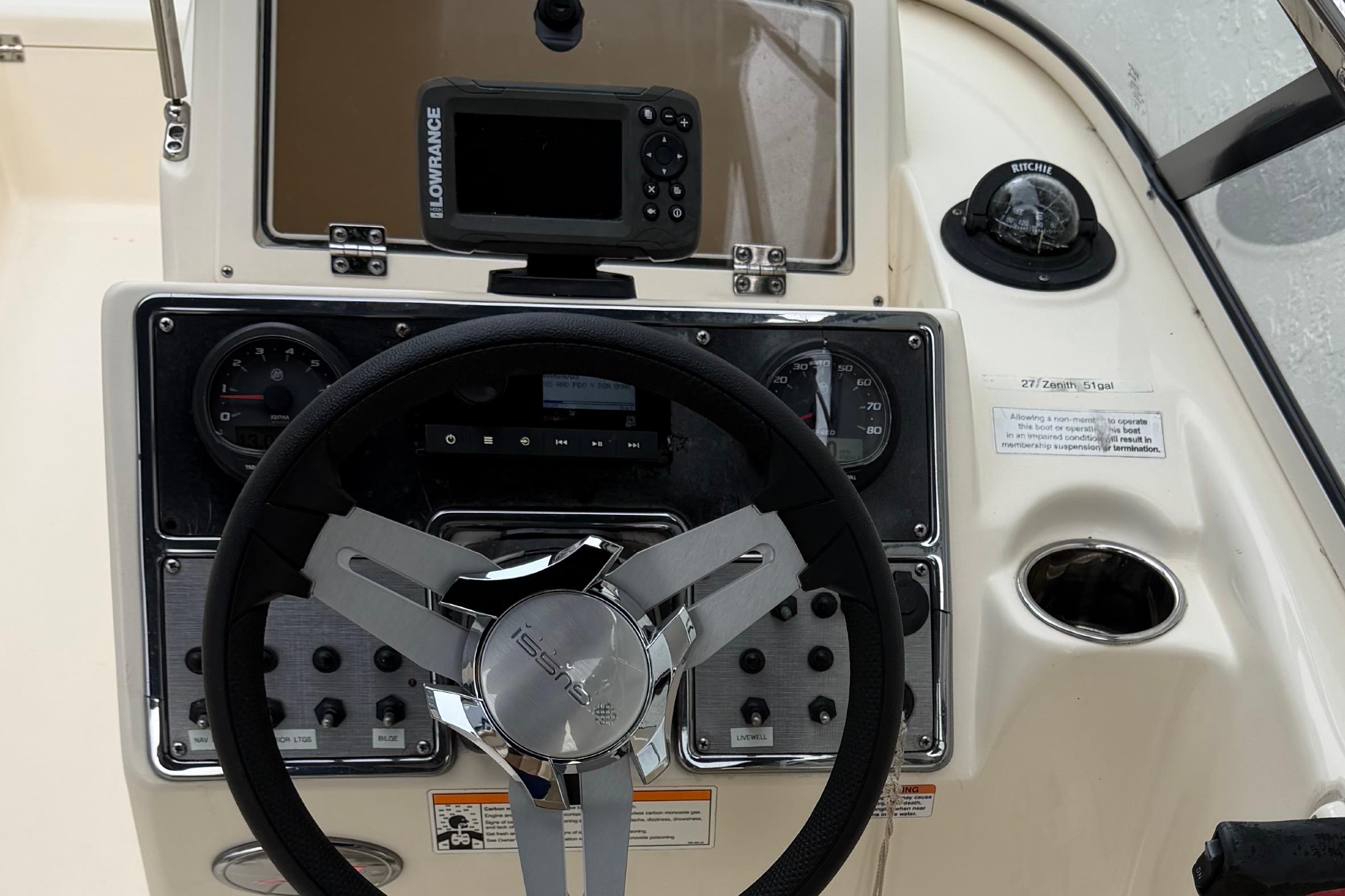 2023 Scout 210 Dorado boat dashboard with steering wheel and navigation equipment.