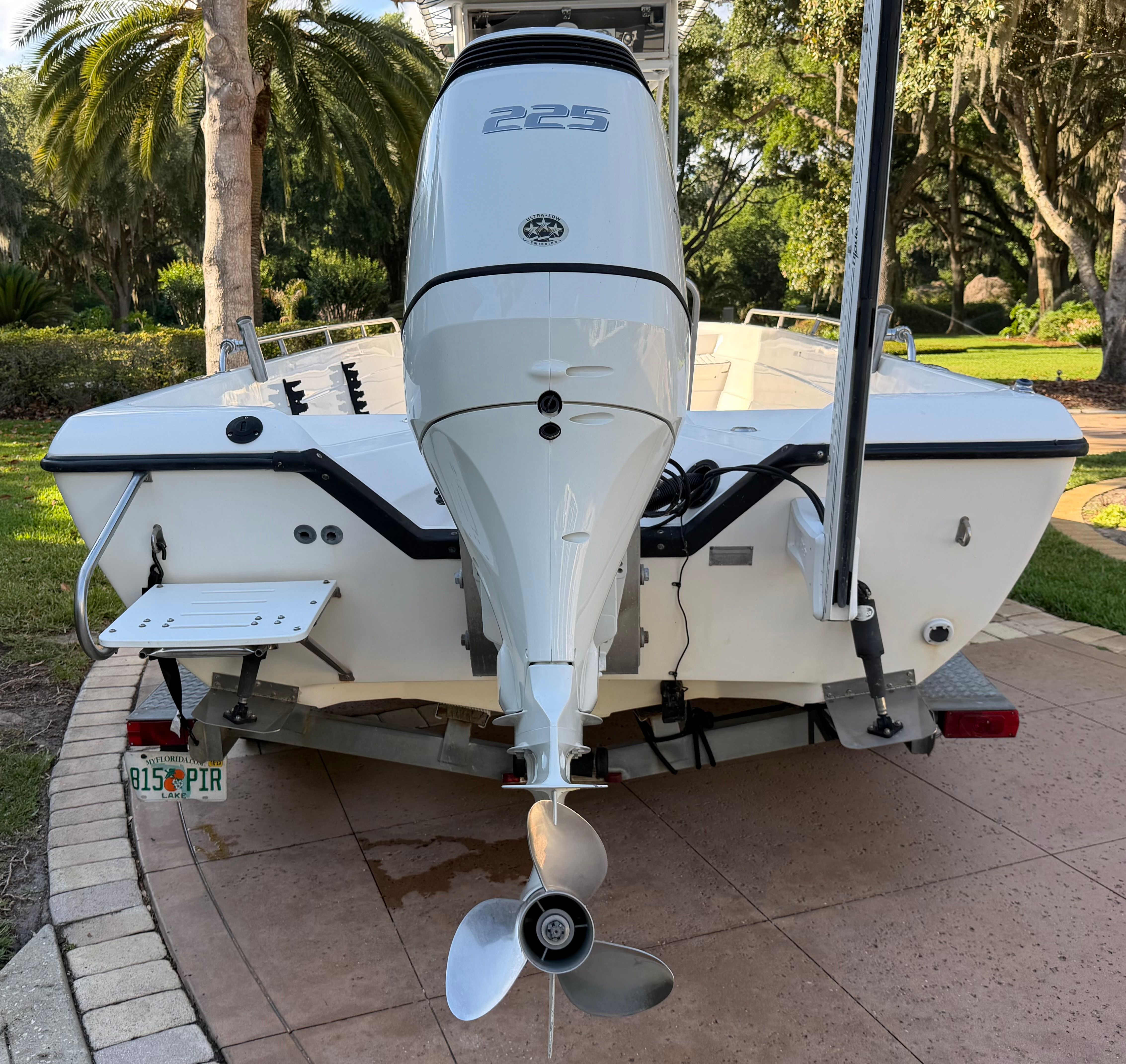 Rear view of a 1999 Skeeter ZX2200 boat with outboard motor.