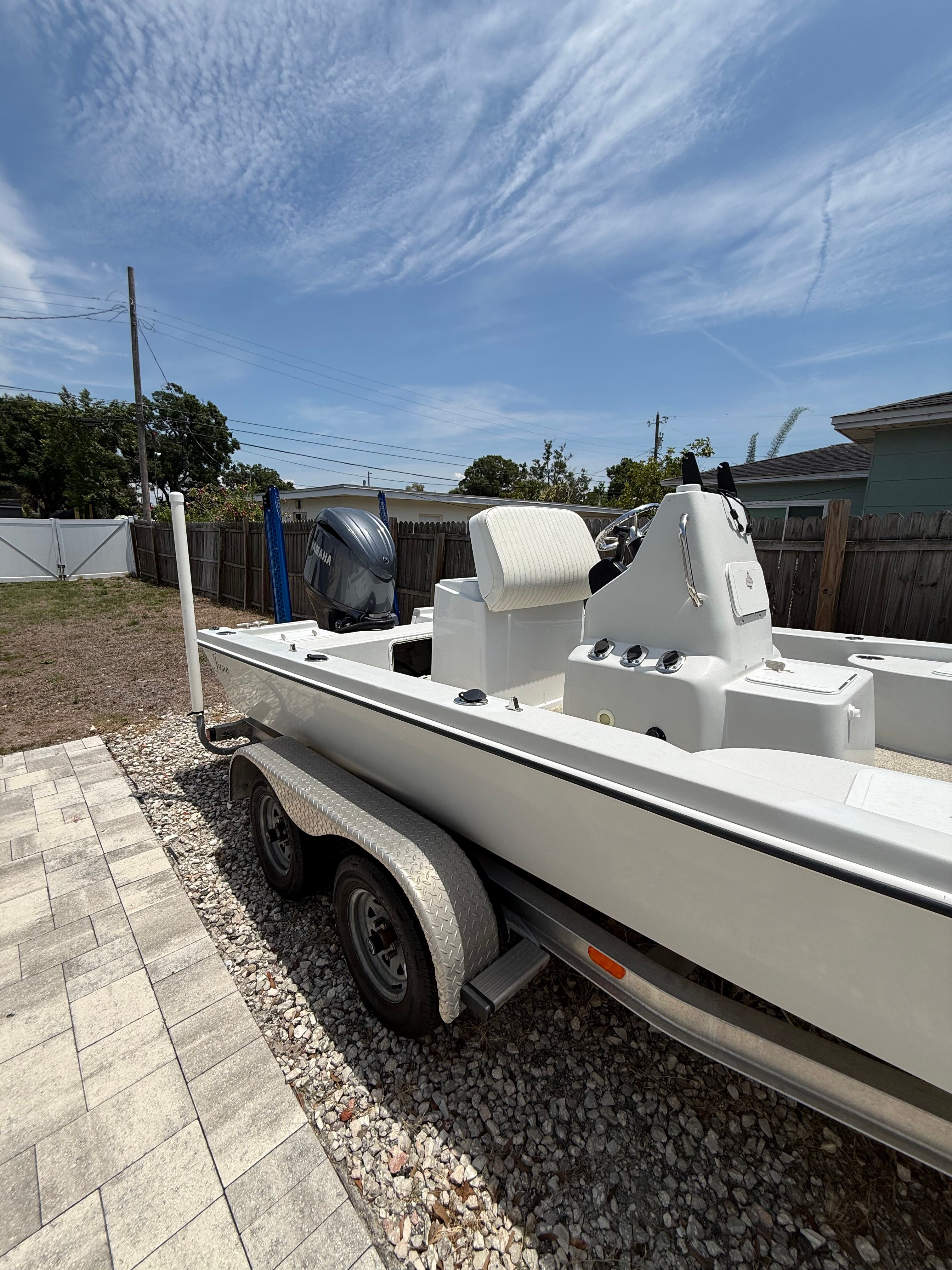 2012 Bay Craft 21 boat on trailer outdoors.