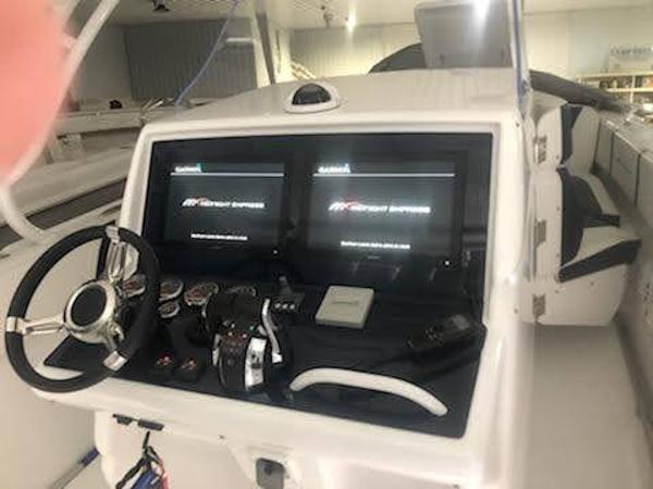 2019 Midnight Express 39 Cuddy boat dashboard with dual screens and steering wheel.